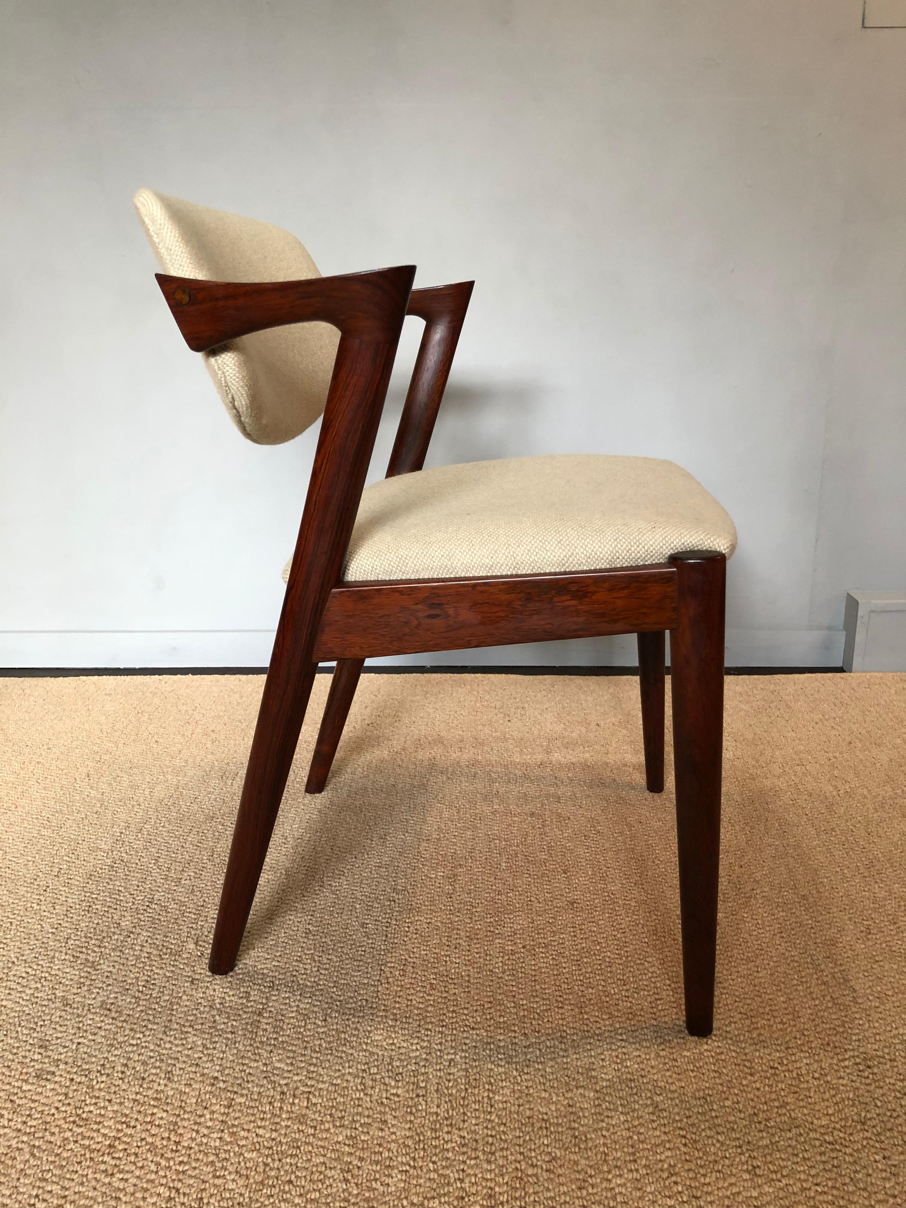 An absolutely superb matching set of original model 42 dining chairs by Kai Kristiansen. Produced by Schou Andersen, Denmark during the 1960s. Stunning walnut frames with wheat off-white weave fabric upholstery and pivot back rests. Fully