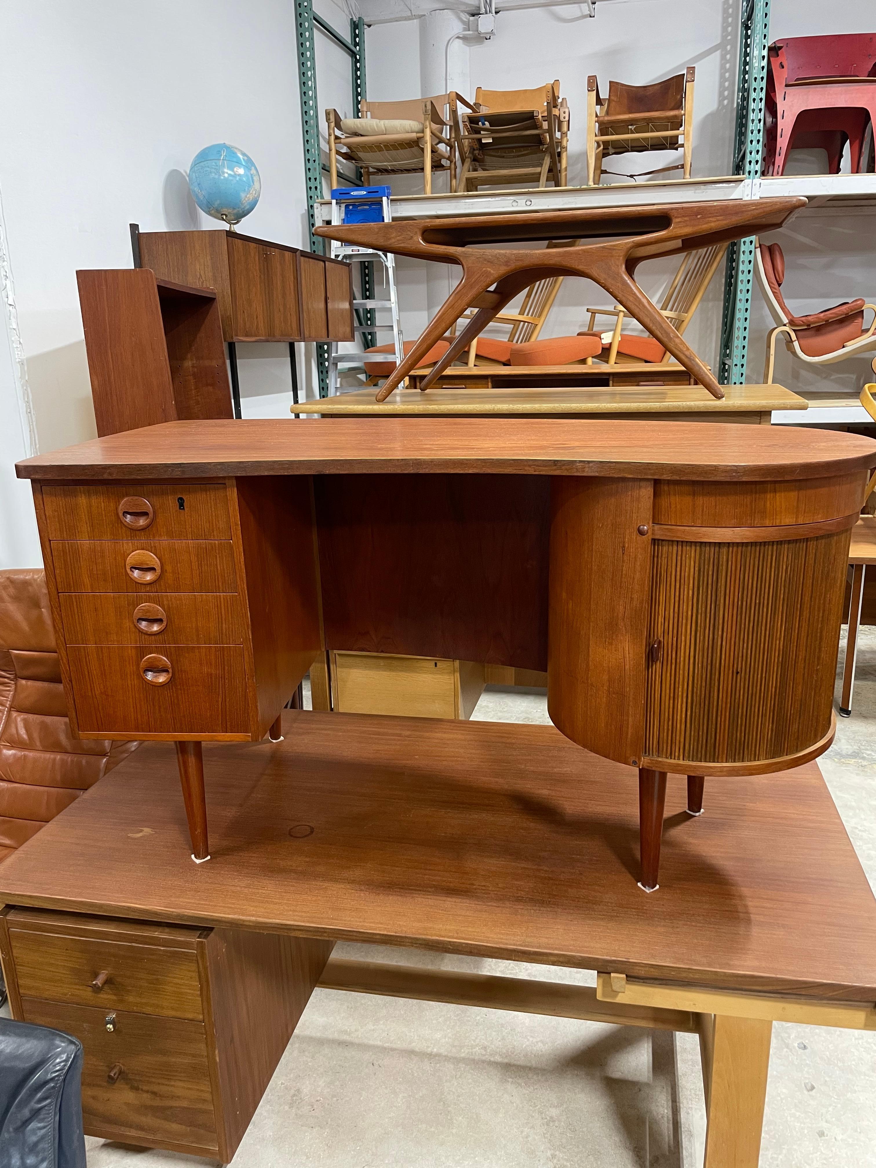 Sought after Kai Kristiansen Model 54 desk. Biomorphic shape. Side bar with tambour door and lazy susan. Finished back so can float on room.