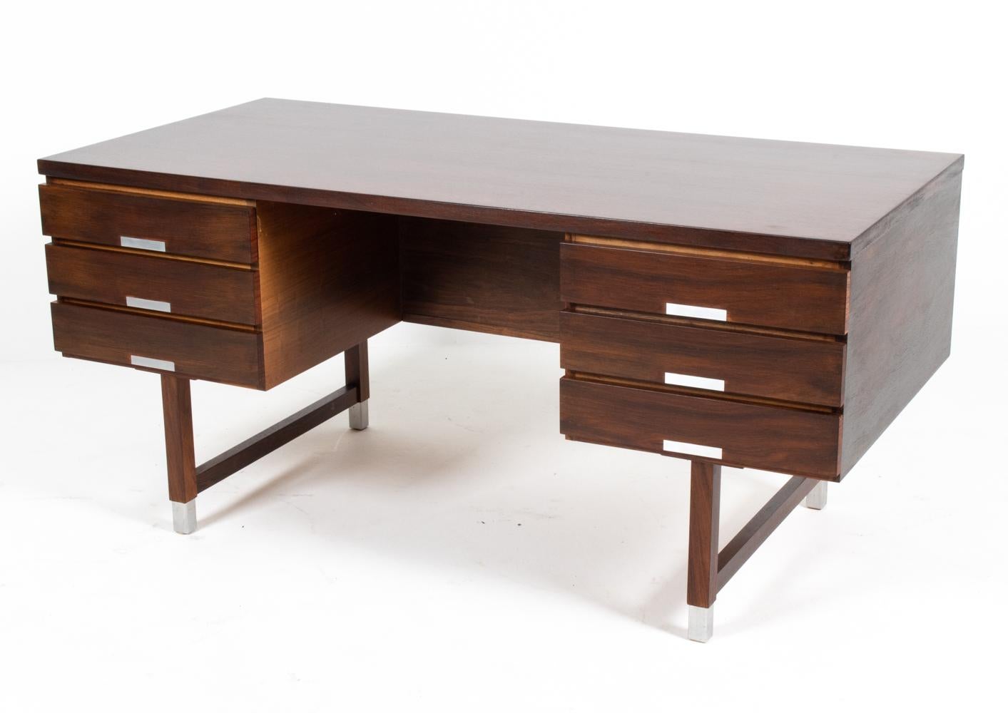 Sleek, elegant, and powerful, the EP 401 desk by Kai Kristiansen is a timeless piece of Danish Mid-Century design. The design features a simple silhouette, with solid secondary woods providing a sturdy foundation for ample storage (six drawers and