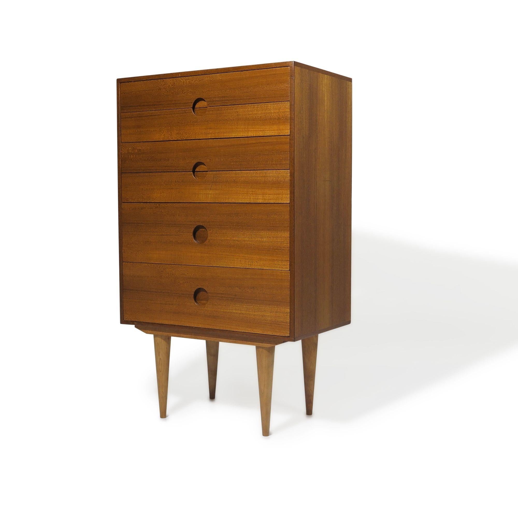 1960s Kai Kristiansen teak dresser with mitered edges, recessed round pulls, and raised on tapered legs. The cabinet has been fully restored with a hand-rubbed natural oil finish. It is in excellent condition with minor signs of age-appropriate
