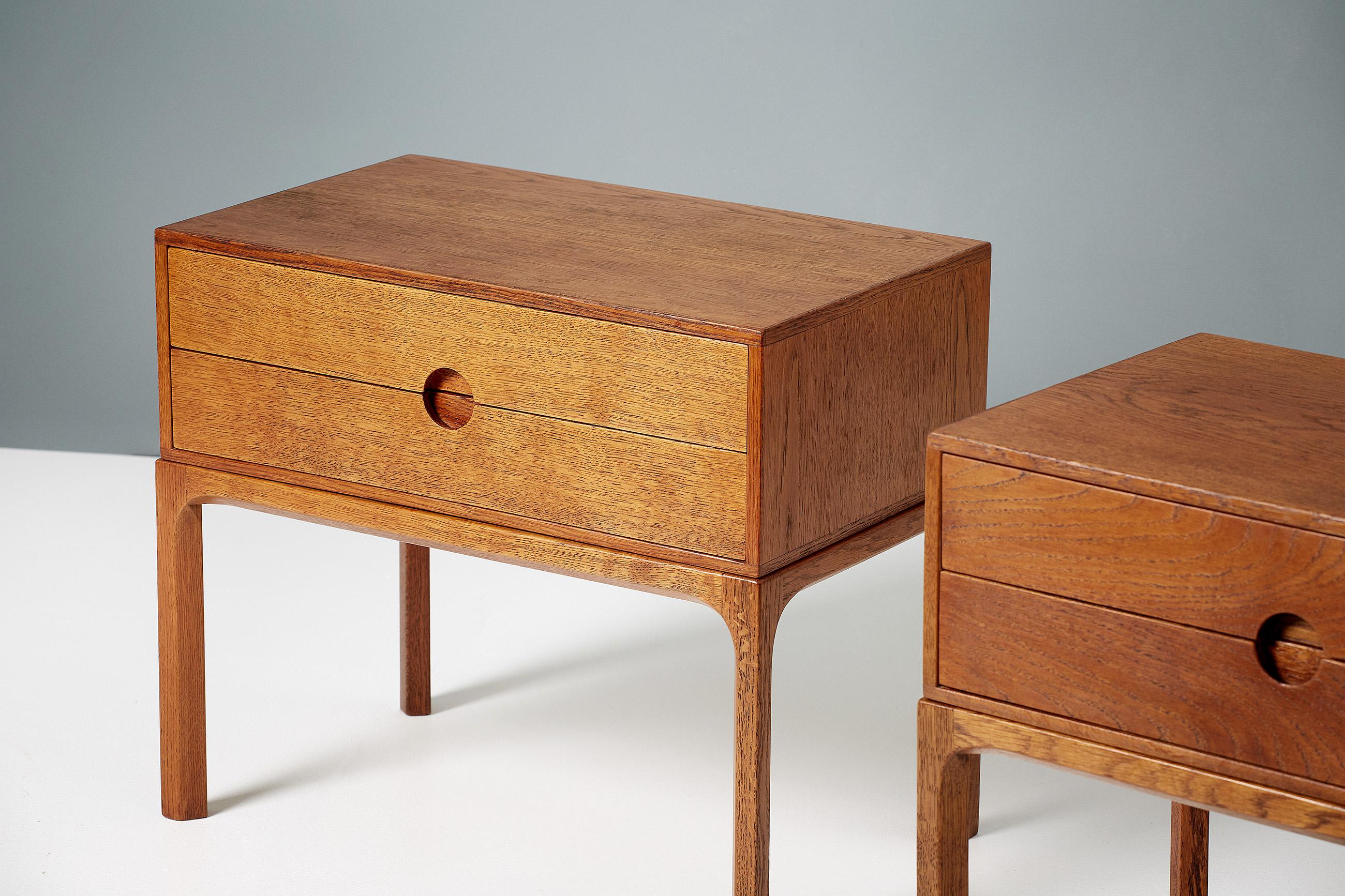 Kai Kristiansen

Bedside cabinets, circa 1960.

Pair of patinated oak bedside cabinets, produced by cabinetmaker Aksel Kjaersgaard in Odder, Denmark, circa 1960. 

Each cabinet has 2 drawers with Kristiansen's trademark circular drawer pull to