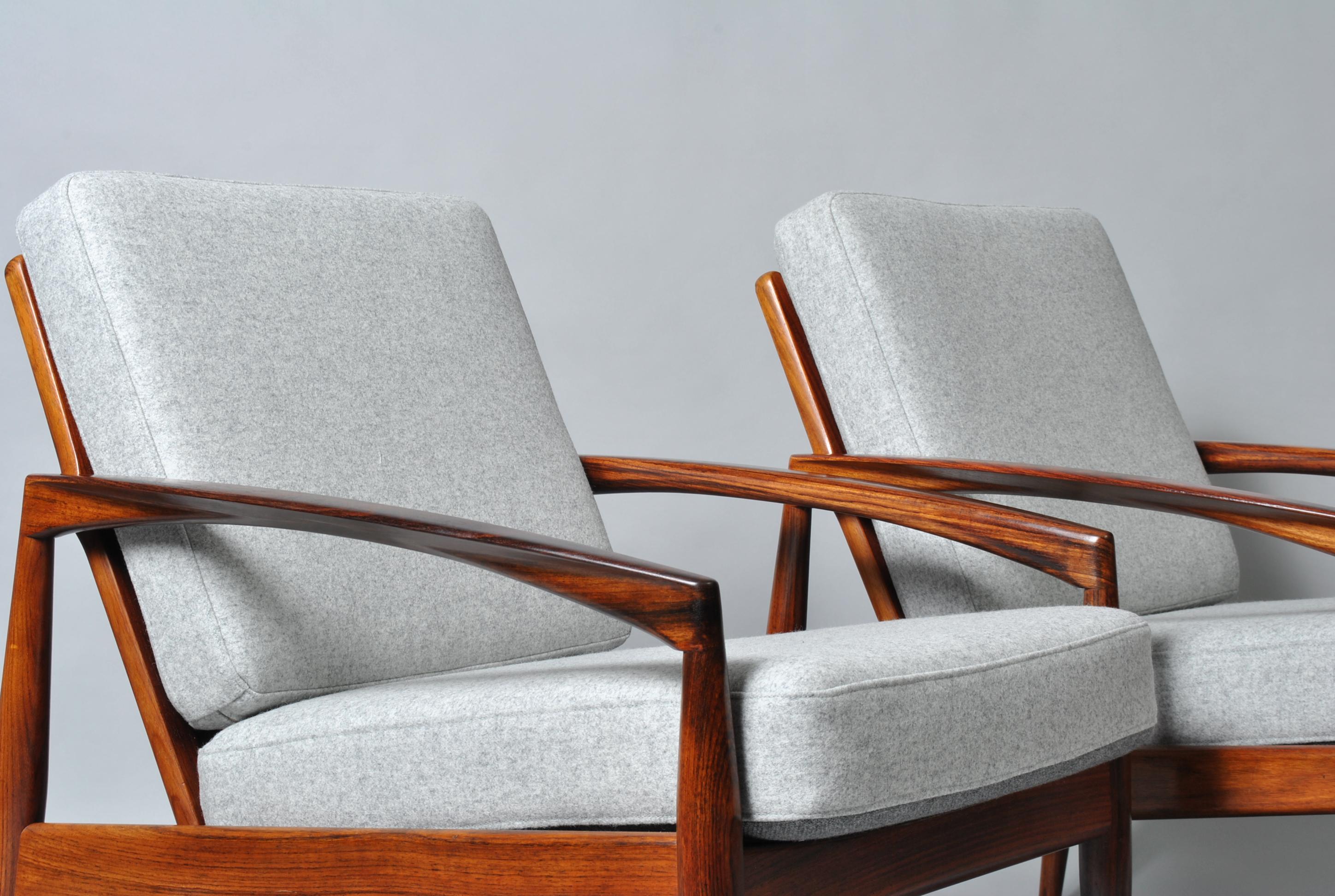 A matching pair of Kai Kristiansen paper knife chairs. They can be purchased separately. Lovely coloured and figured frames which have been thoroughly cleaned and polished. Fully reupholstered in reversible light grey felt and grey wool weave. The