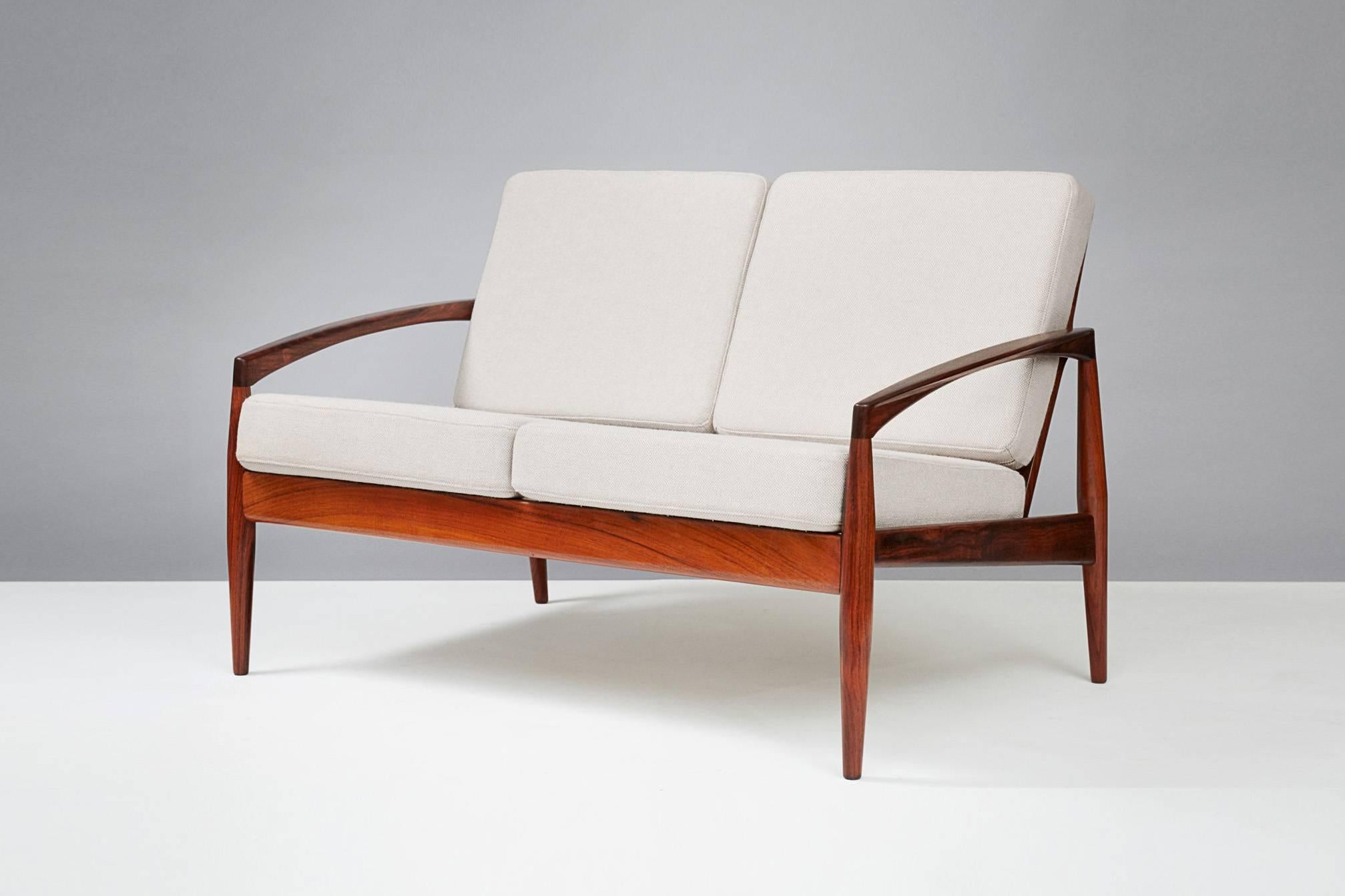 Kai Kristiansen

Paper knife sofa, 1955

Produced by Magnus Olesen, Denmark. Rarely seen example on the two person sofa made from rosewood. New cushions covered in Kvadrat Hallingdal #103 wool fabric.