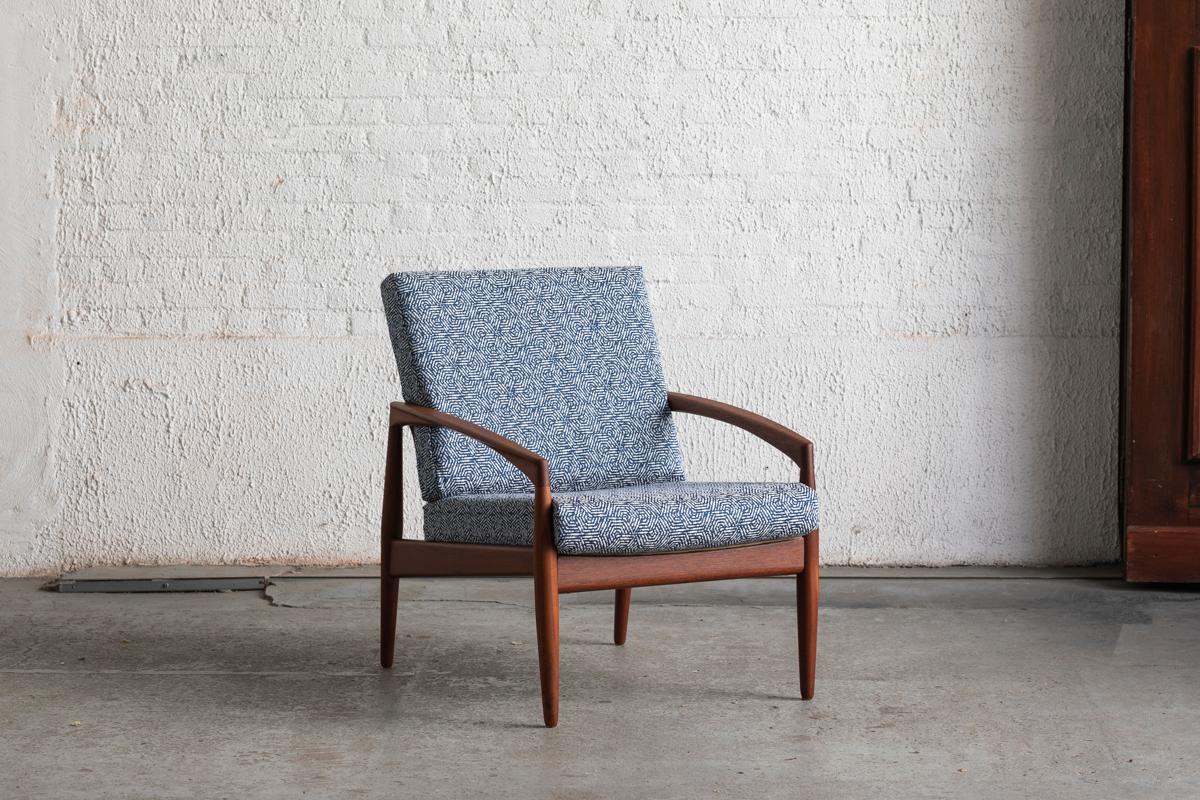 Easy chair designed by Kai Kristiansen and produced by Magnus Oleson in Denmark, 1955. This ‘model 121’ also called the ‘Paper knife’ chair because of it’s razor sharp lines, is executed in teak with brass details. The cushions and patterned