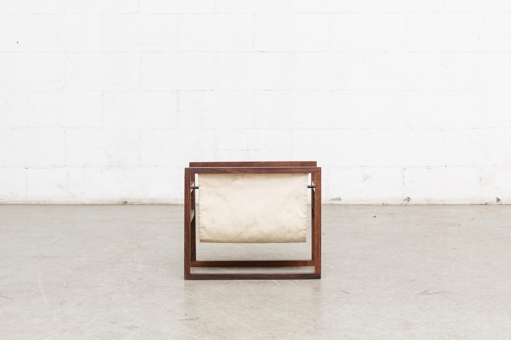 1960s Kai Kristiansen rosewood and canvas magazine rack. Lightly refinished wood frame and original off-white canvas. Good original condition.