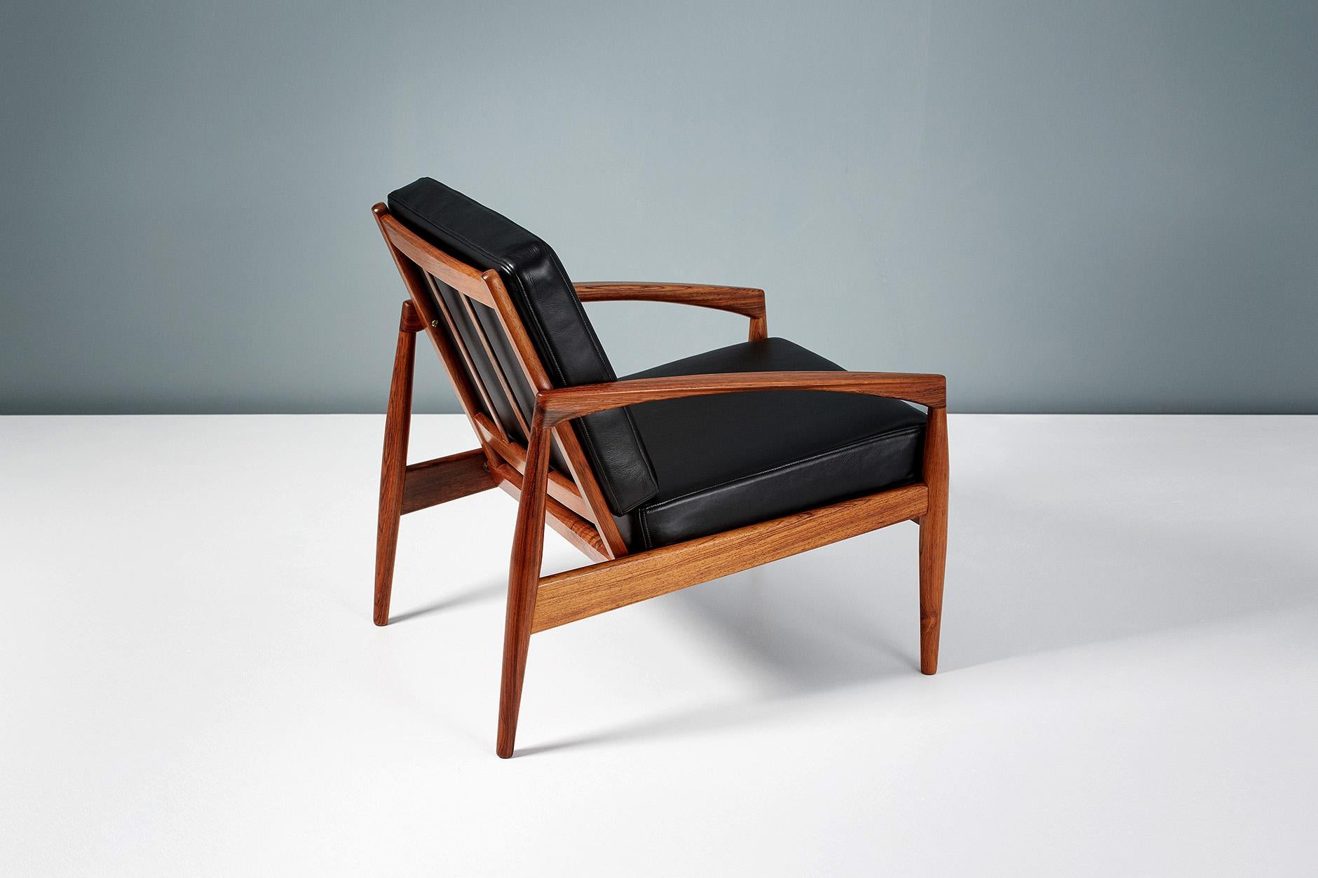 Kai Kristiansen

Paper knife lounge chair, 1955.

Produced by Magnus Olesen, Denmark in highly figured South American rosewood. New cushions upholstered in premium black aniline leather. 

Other upholstery options available by request.

 