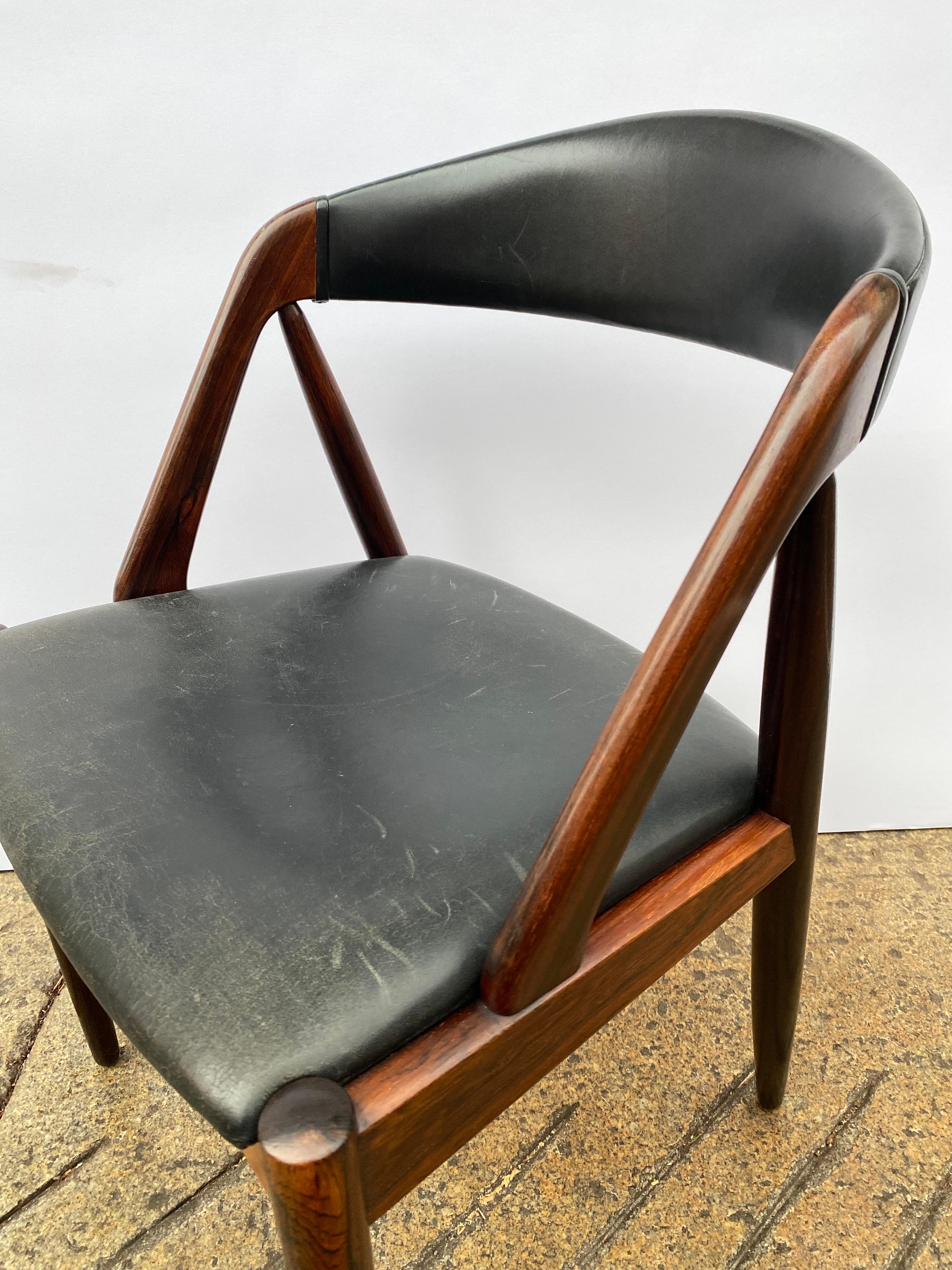 Kai Kristiansen rosewood and black leather dining or desk chair. Beautiful rosewood with the original leather seat pad. Overall chair is very solid! Leather shows typical signs of use and wear. Rosewood is rich in color with no fading!