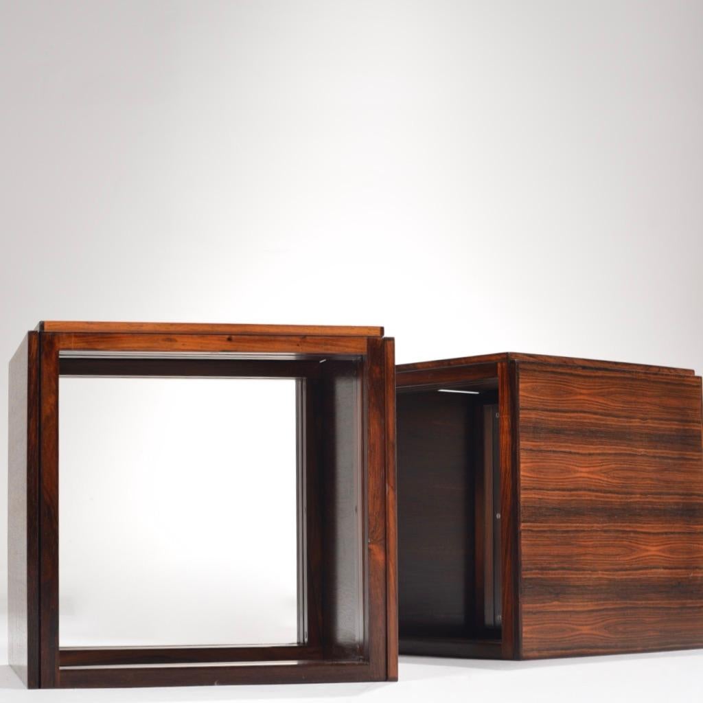 Rosewood square/cube nesting tables - each 'nesting table' contains three rosewood tables that fit into each other (creating a total of six tables when separated.)
The squared legs and beautiful wood grain make these tables effortlessly sleek. Sold