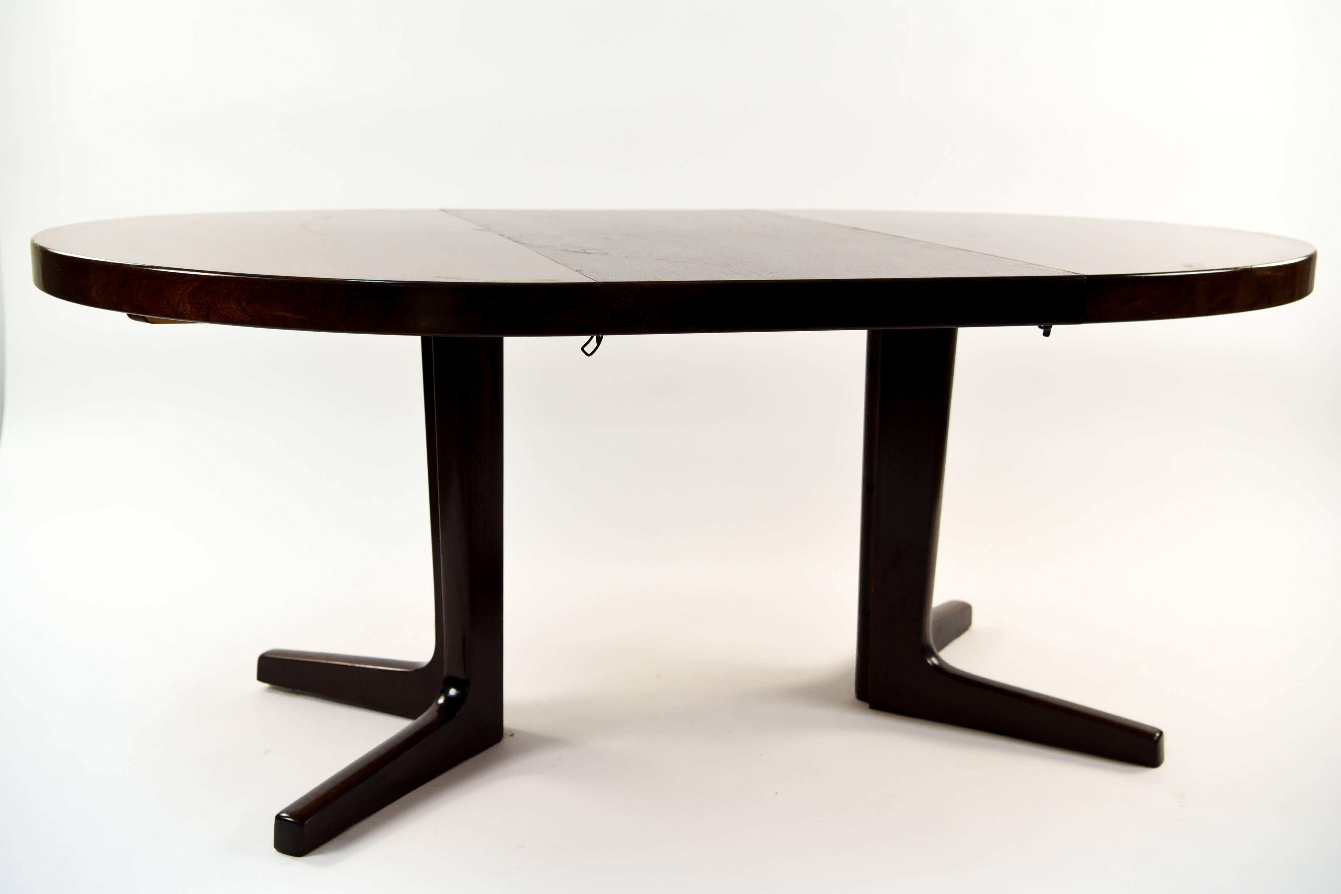 This dining table is by iconic Danish midcentury designer Kai Kristiansen. It includes one leaf which expands the table to 67.25