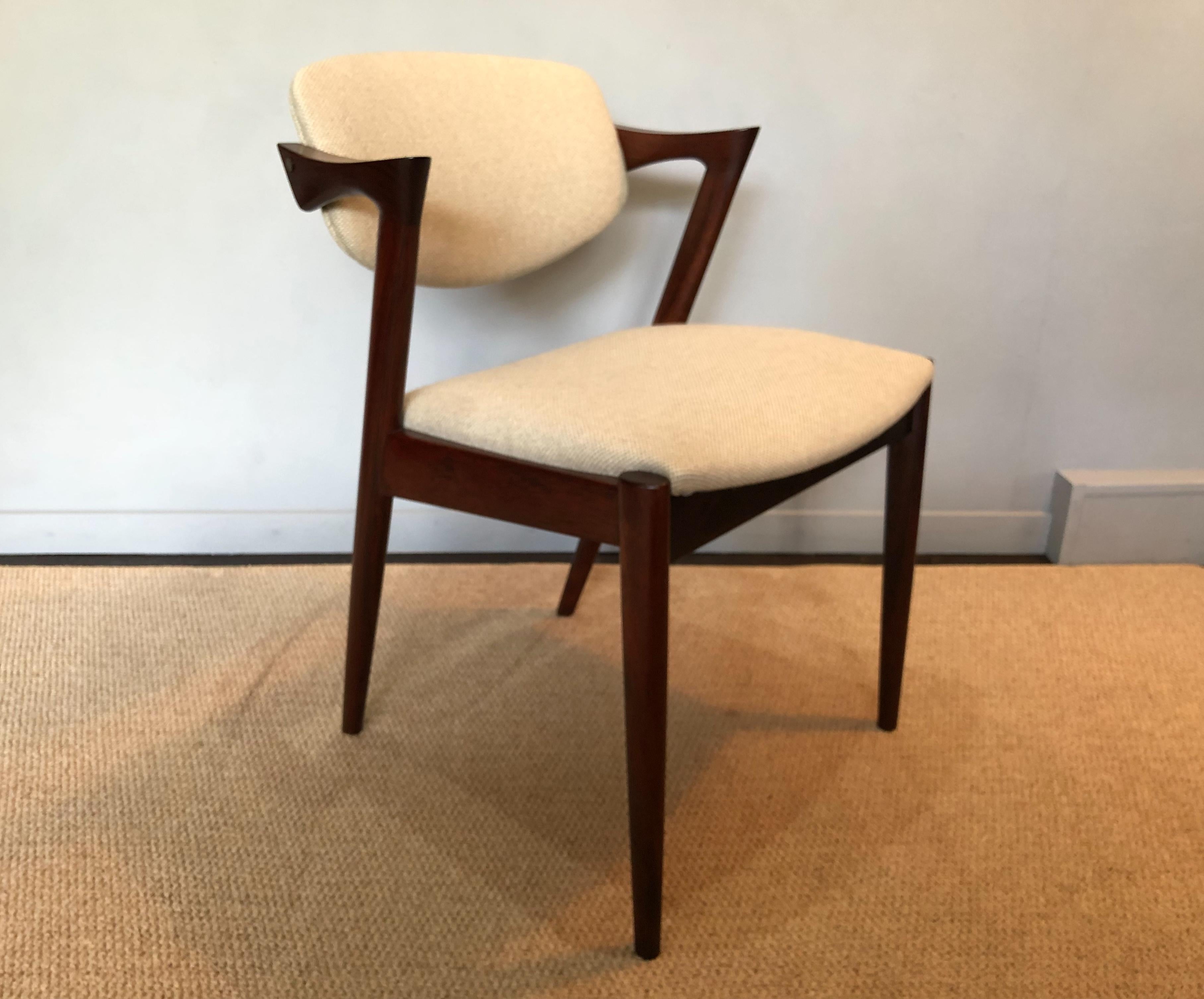 The Classic rosewood model 42 chairs from Kai Kristiansen. Off-white weave upholstery. Custom upholstery is available upon request. Produced circa 1960. The frames have a superb coloring and figuring. In great vintage condition, thoroughly cleaned