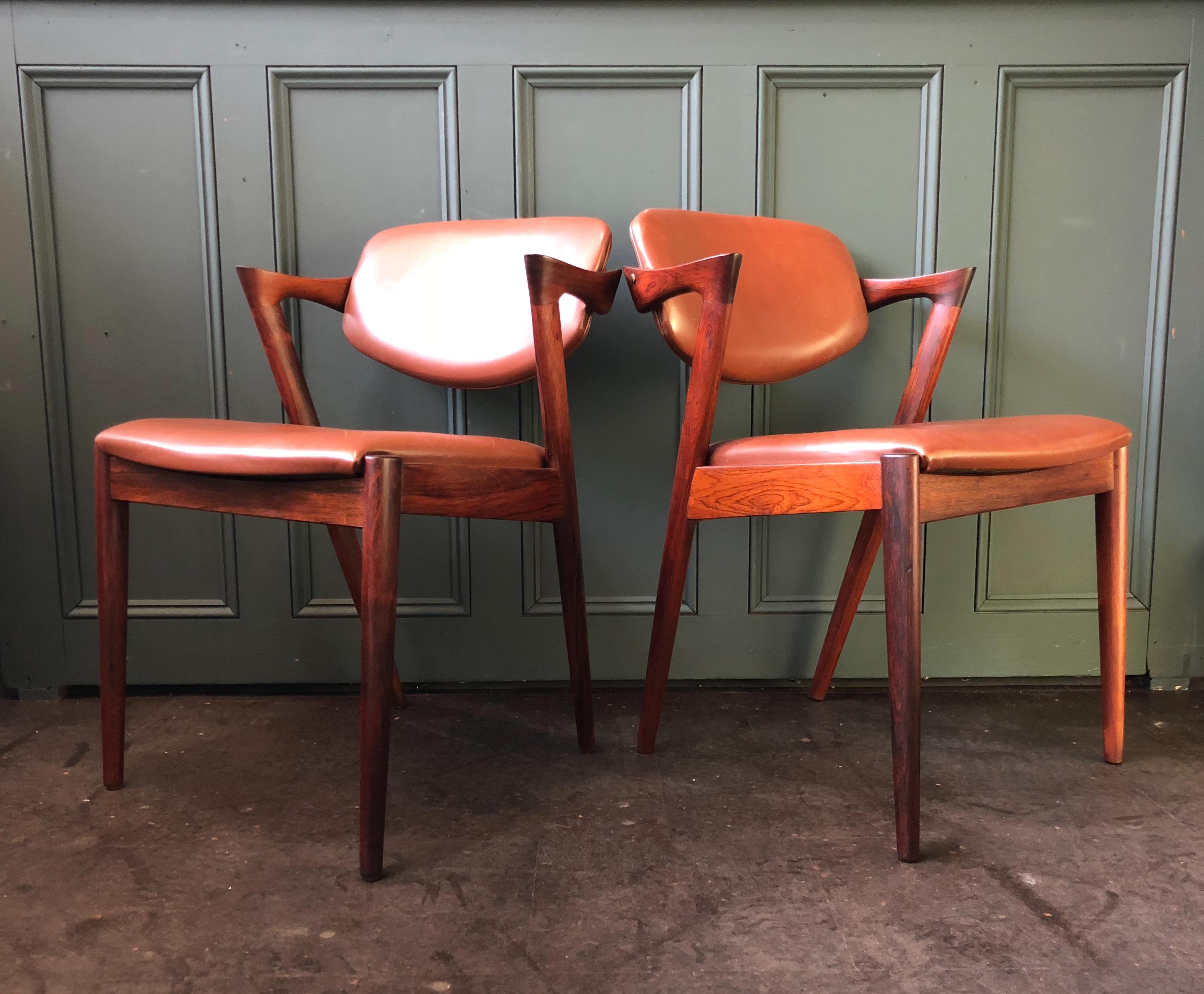 Lovely matching pair (more in stock) of rosewood model 42 chairs from Kai Kristiansen. Mid brown original leather upholstery, circa 1960. The frames have a superb coloring and figuring. In great vintage condition, thoroughly cleaned and re-oiled.
 