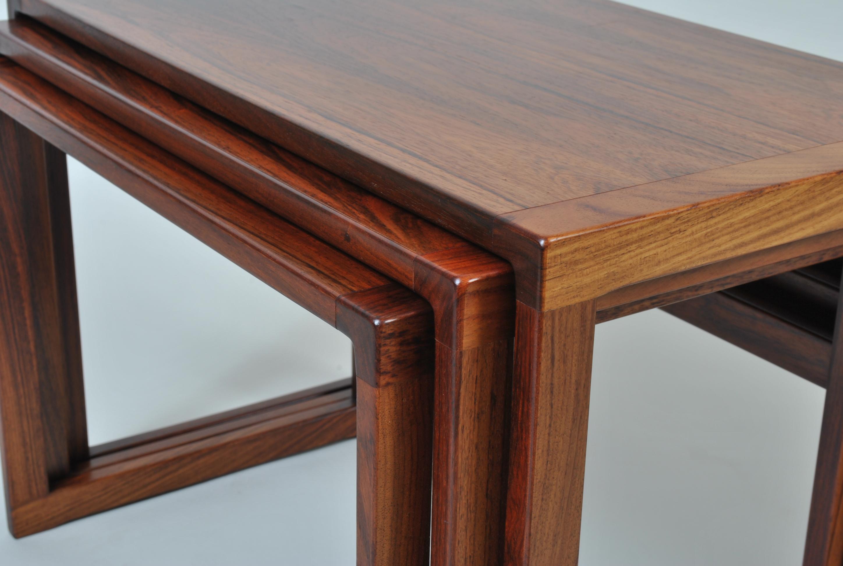 A set of rosewood nesting tables by the ever popular Kai Kristiansen. Designed by Kai Kristiansen - Produced by Vildbjerg Mobelfabrik, Denmark circa 1960. Superb modernist design and very practical.
  