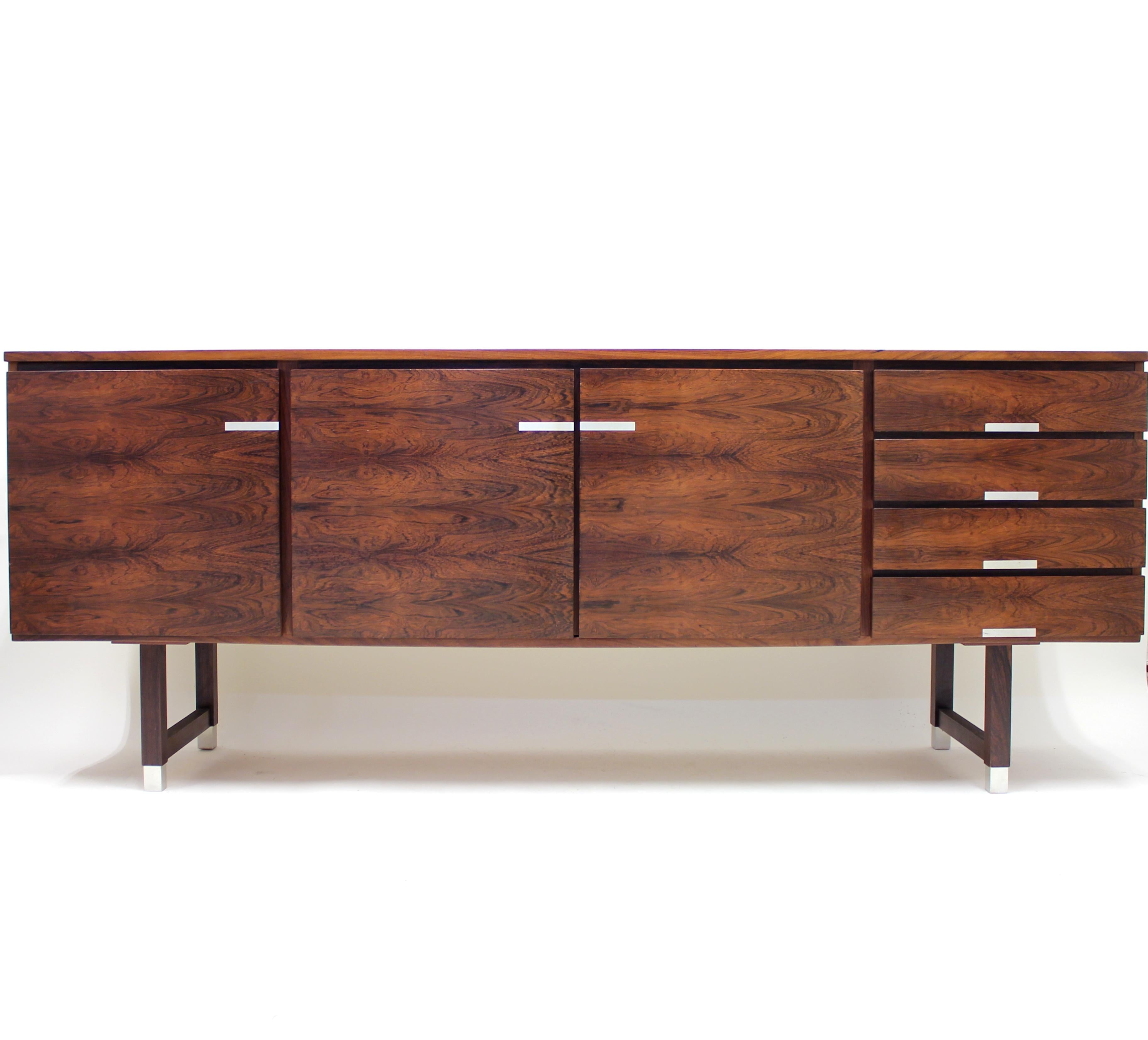 Danish sideboard from the 1960s by Feldballes Møbelfabrik. Made in rosewood veneer over an oak core with aluminium handles and feet. It features two compartments with shelfs and a set of 4 drawers to the right. Overall in a good vintage condition