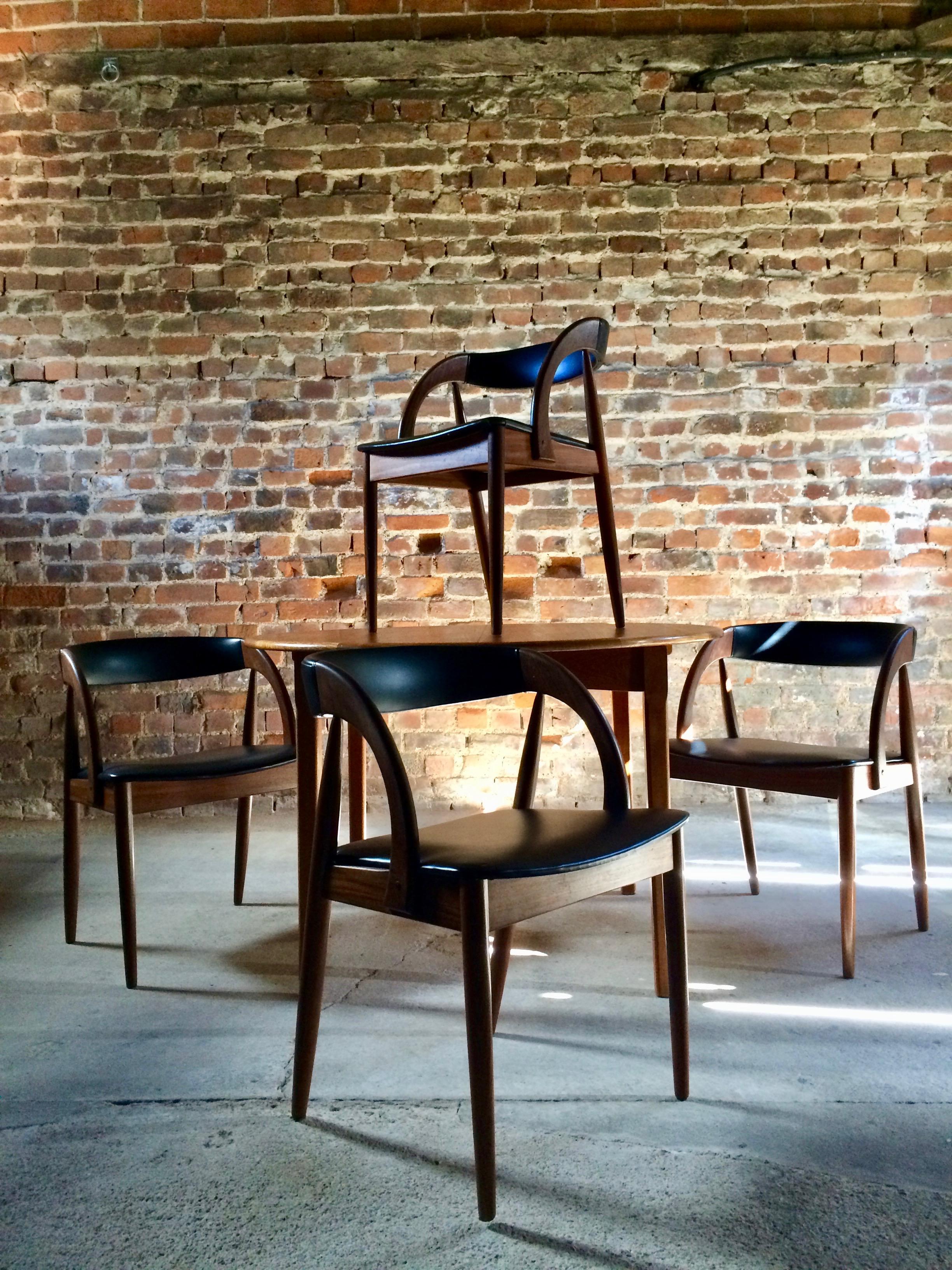 Danish design 20th century circular extending dining table by Kai Kristiansen and a set of four rosewood chairs circa 1970, the teak circular table with a butterfly extension leaf hidden to the underside of table with a smooth opening and closing