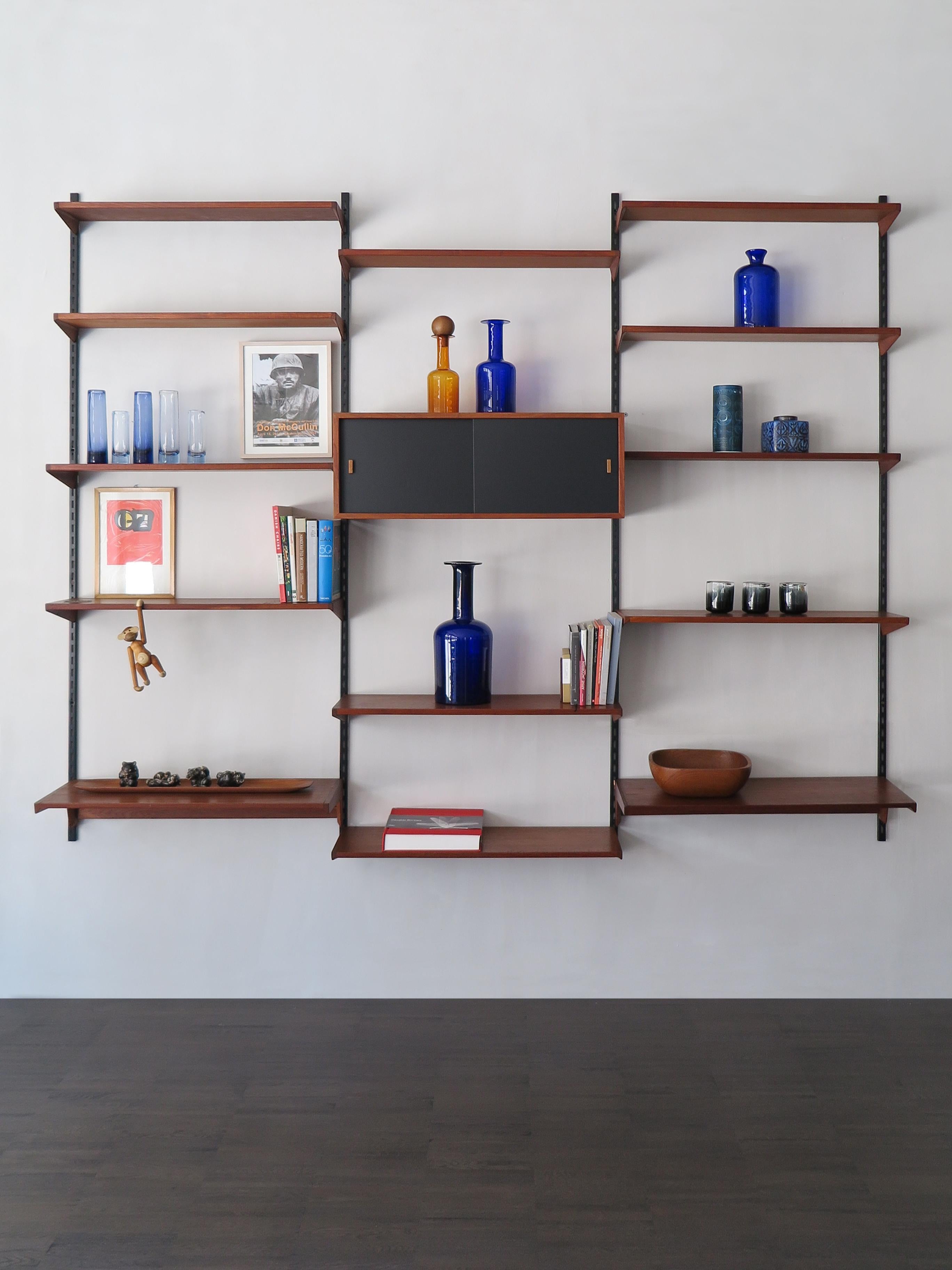 Scandinavian teak shelving system designed by danish artist Kai Kristiansen for FM Mobler, wood box and shelves can be positioned as desired; original uprights ( see photos ) and manufacture label., circa 1960.

Please note that the item is