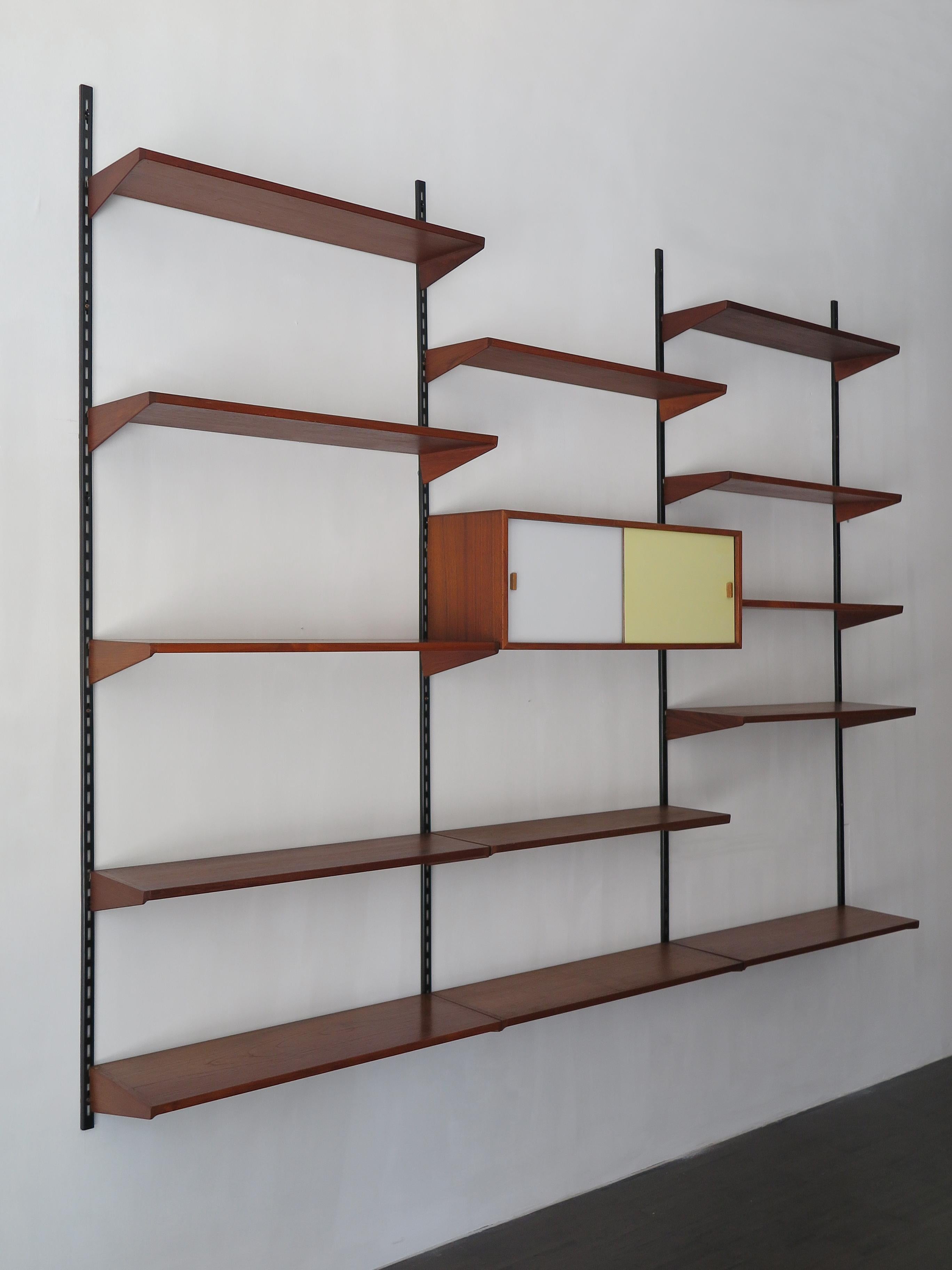 Danish teak shelving system designed by Kai Kristiansen for FM Mobler, shelves and container can be positioned as desired, circa 1960.
Please note that the item is original of the period and this shows normal signs of age and use.