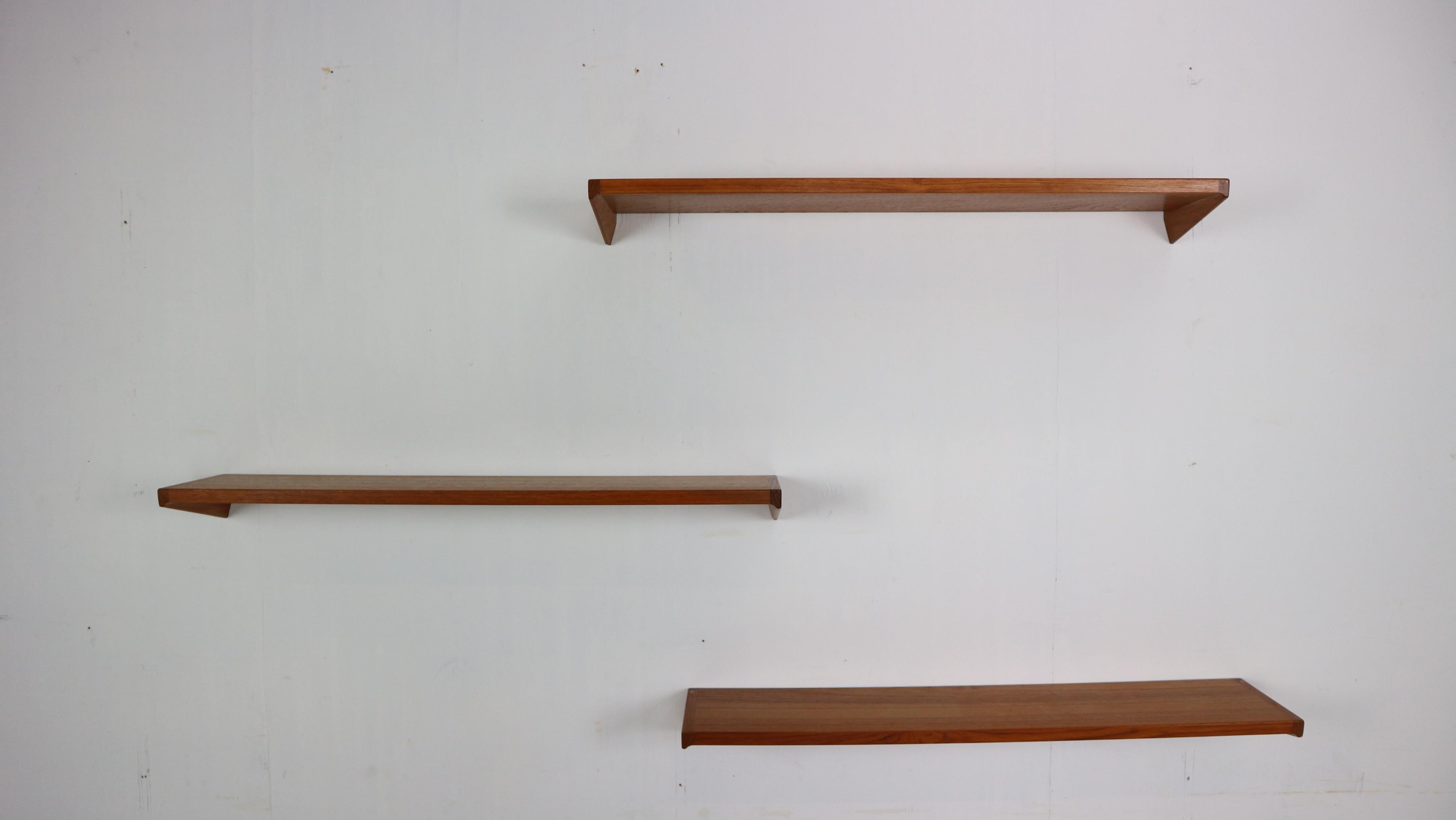 Mid- Century modern period set of 3 floating wall shelfs designed by Kai Kristiansen for the Danish publisher Feldalles Møbler in the 1960s. 
This designer is a major figure in 20th century Scandinavian designs.

The shelves are made of teak wood