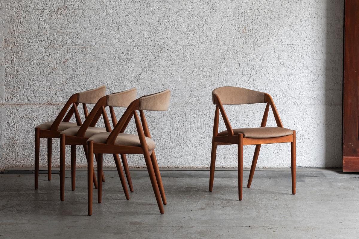 Set of 4 dining chairs ‘Model 31’, designed by Kai Kristiansen and produced in Denmark in the 1960s. The chairs feature a solid, teak wooden frame with a beige upholstery in velours. One lighter stain, further in very good condition. 

Price of 3500