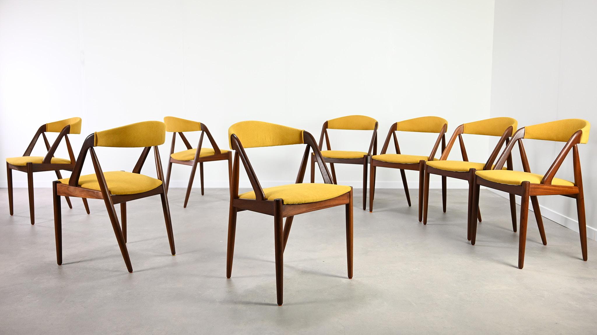 Set of 8 chairs, model 31, by Kai Kristiansen for Schou Andersen. A beautiful example of Danish design from the sixties. Structures made of solid teak, seats and backrests reupholstered in yellow fabric. Small traces of use on the teak, excellent