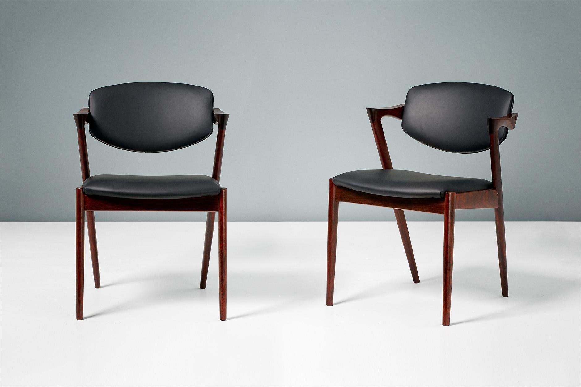Kai Kristiansen

Model 42 dining chairs, 1956.

Set of 8 dining chairs produced by Skovman Andersen for the Illum Bolighus department store in Copenhagen. Refinished rosewood frames with seat and back reupholstered with premium black leather.
