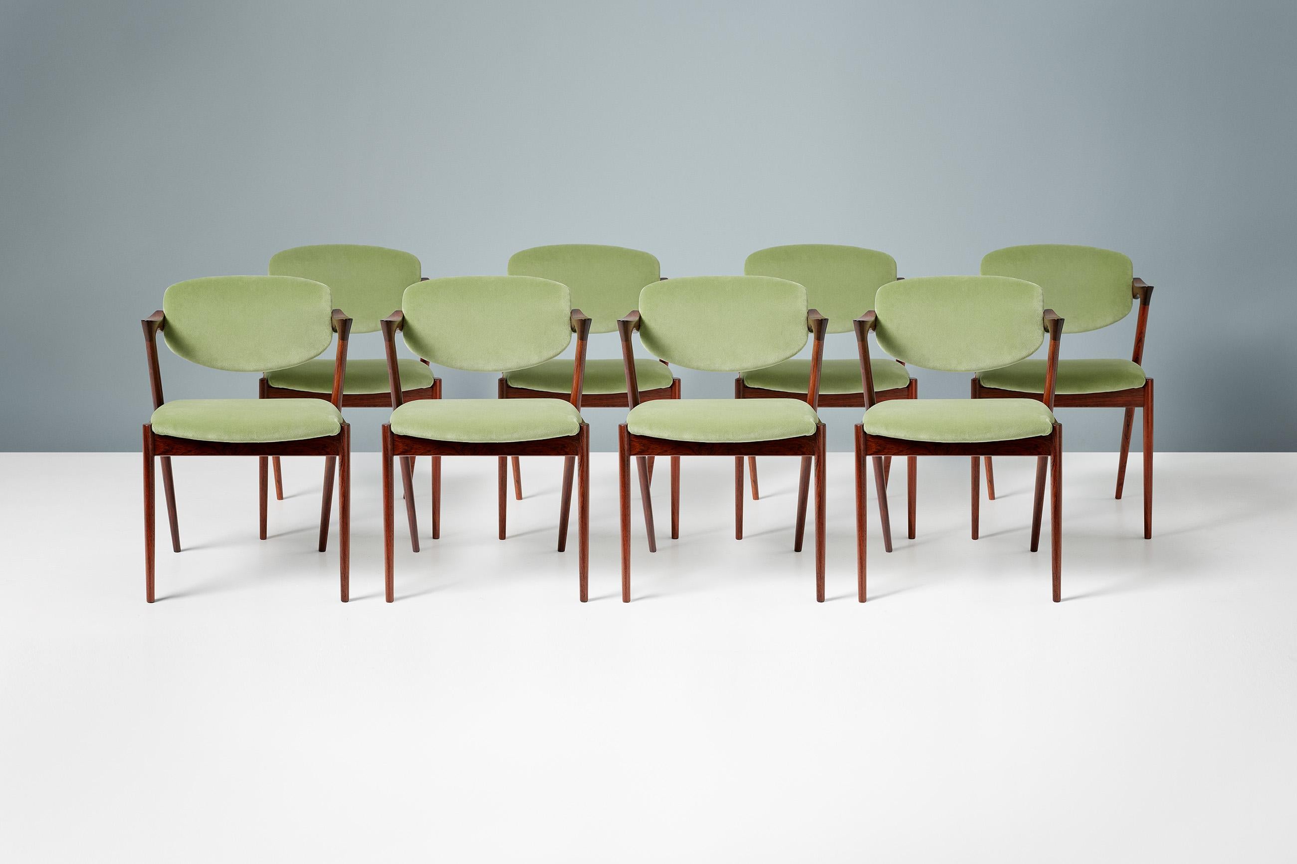 Kai Kristiansen

Model 42 dining chairs, 1956.

Set of 8 dining chairs produced by Skovman Andersen for the Illum Bolighus department store in Copenhagen. The frames are made from the highest quality Brazilian rosewood which have been