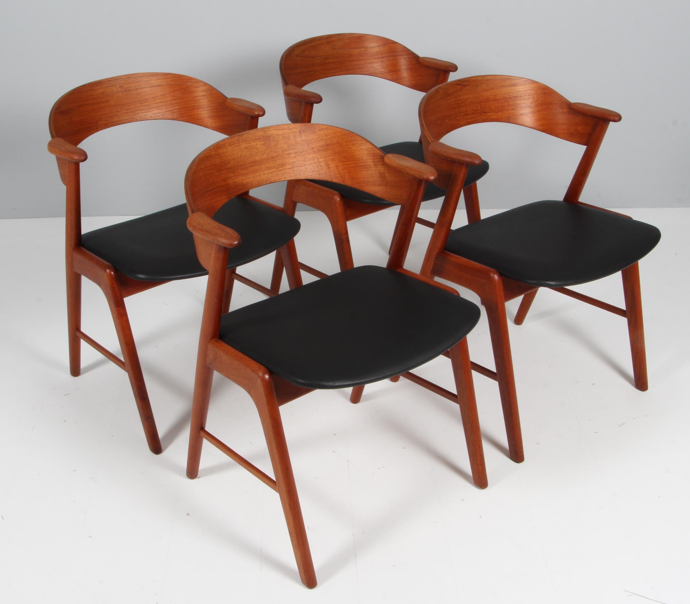 Kai Kristiansen for KS Møbler, set of 6 dining chairs, teak , black aniline leather, Denmark, 1950s. 

The chairs show beautiful and well designed lines and joints. The curved back and armrests are mounted on the oblique rear legs, which provides