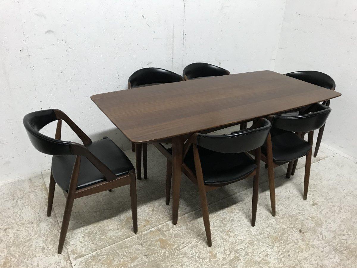 Kai Kristiansen. 
A set of six teak framed, Model 31 dining chairs with curved upholstered backs and a matching rectangular teak dining table, very sleek and compact but spacious when sat at and comfortable.
This suite is in wonderful original