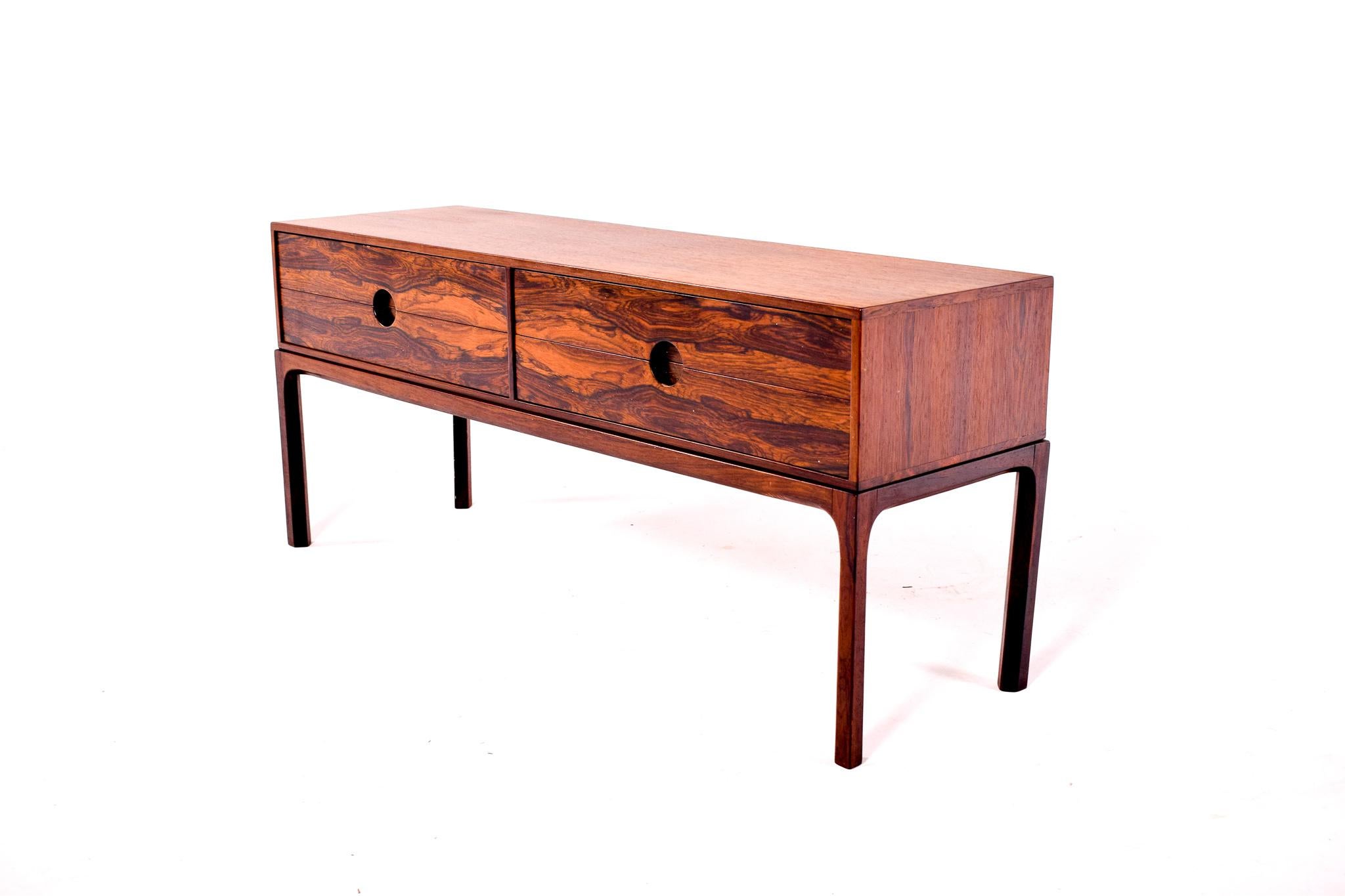 This rosewood low sideboard or side table model no. 394, designed by famous Danish designer Kai Kristiansen and manufactured Aksel Kjersgaard, will add charm to your home. The sideboard’s design follows in the vein of Scandinavian functionality,