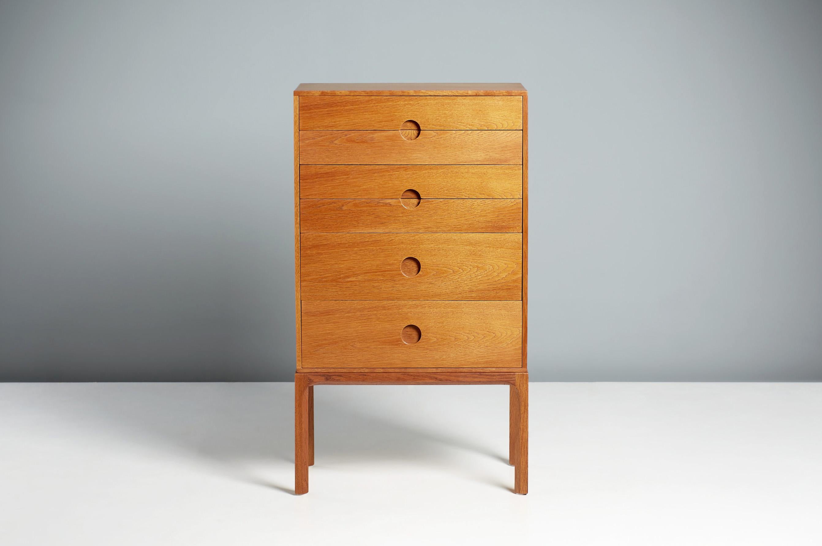 Kai Kristiansen Model 385 Chest of Drawers, circa 1960.

Oak tallboy chest, produced by Aksel Kjersgaard in Odder, Denmark. Solid oak frame with veneered cabinet and half-moon drawer pulls. Refinished in Danish oil. Rarely seen model from this