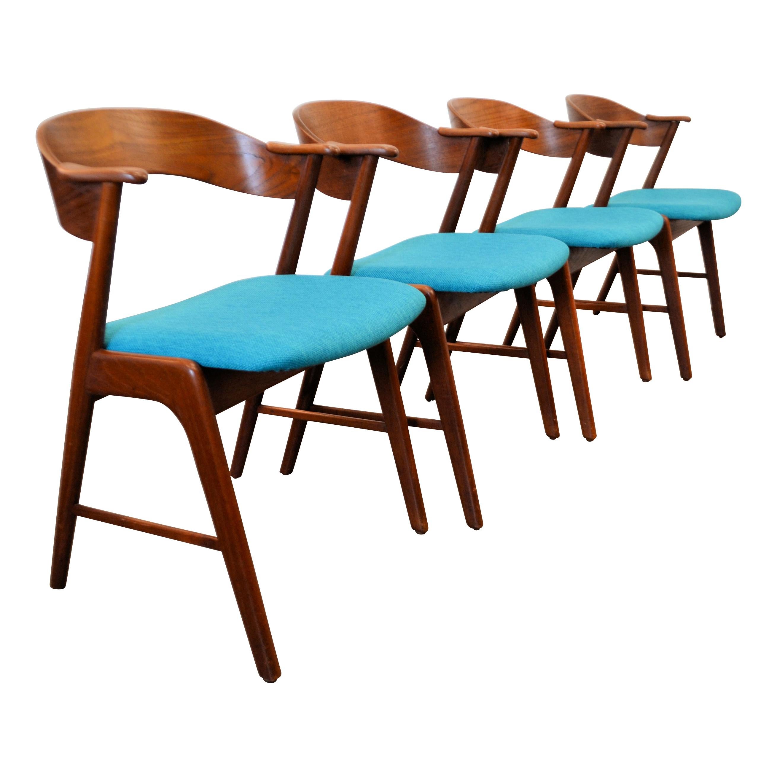 Gorgeous set of four vintage teak dining chairs designed by Kai Kristiansen for Danish manufacturer Korup Stølefabrik. Kristiansen became worldwide known and celebrated for his iconic dining chair designs. These comfortable Mid-Century Modern chairs