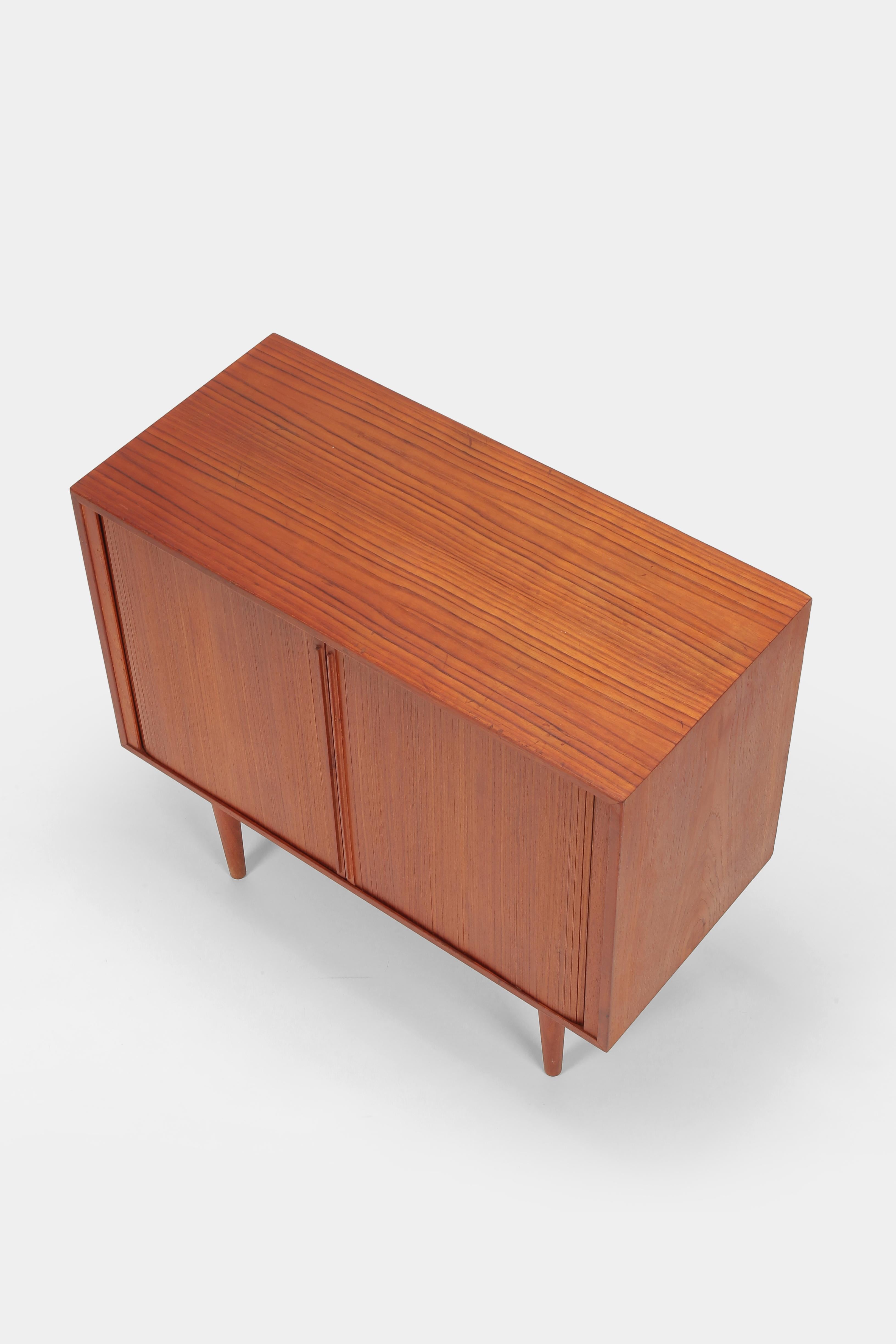 Kai Kristiansen chest of drawers made by FM Moebler in Denmark in the 1960s. Elaborately crafted tambour doors in solid teak, teak veneer and maple interior. Beautiful, practical piece of furniture, meticulously finished with slight signs of