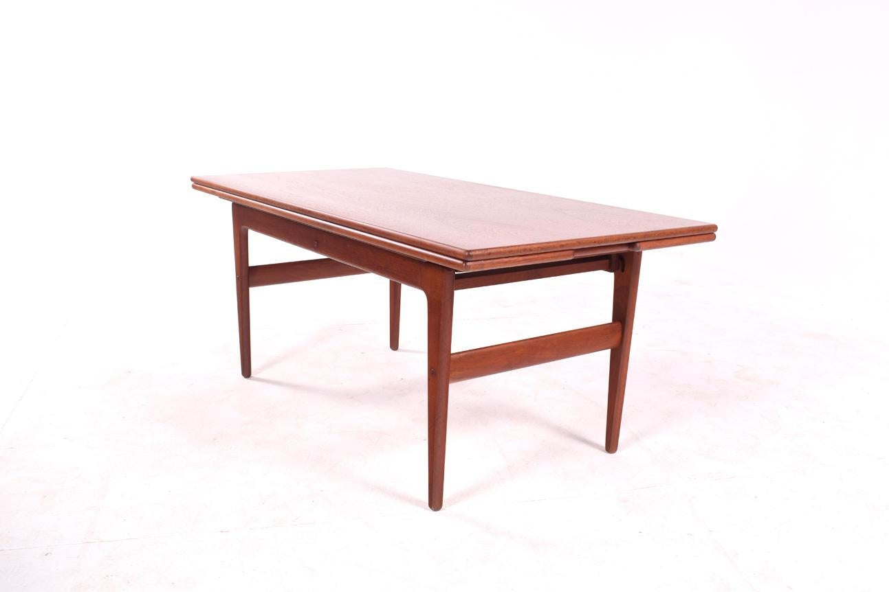 Teak coffee/dining table, extendable. Design by Kai Kristiansen for Trioh in 1960. This table could be used as an everyday coffee table by day and a buffet or dining table by night. Dimensions after unfolding: height 69 cm, depth 106 cm.