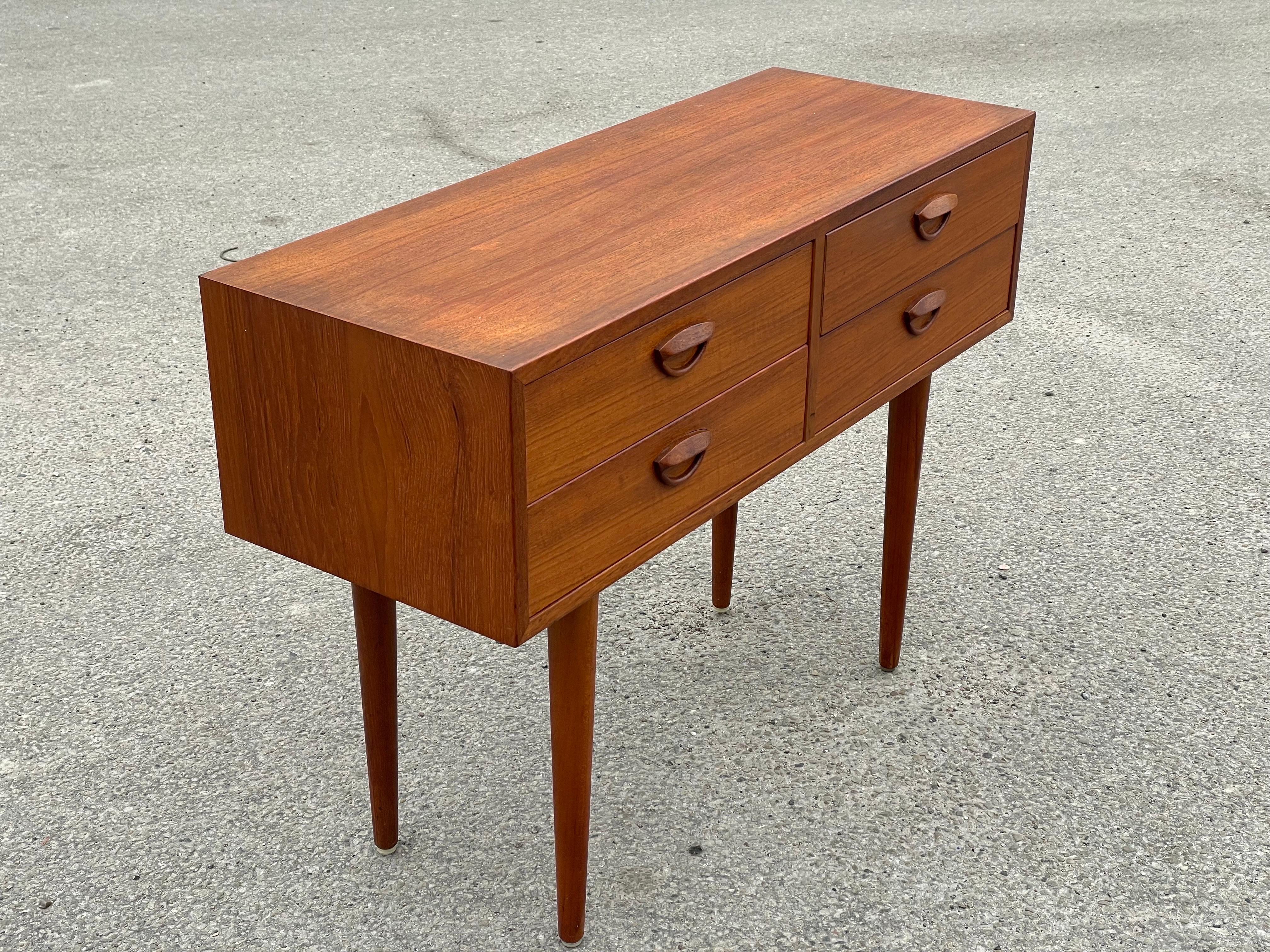 Chest of drawers designed by Kai Kristiansen and produced by Feldballes Møbelfabrik, Denmark in the 1960s. This cabinet is made of teak and has beautiful detailed lines with his signature eyelid handles, typical of Kristiansen's work. Sits on turned