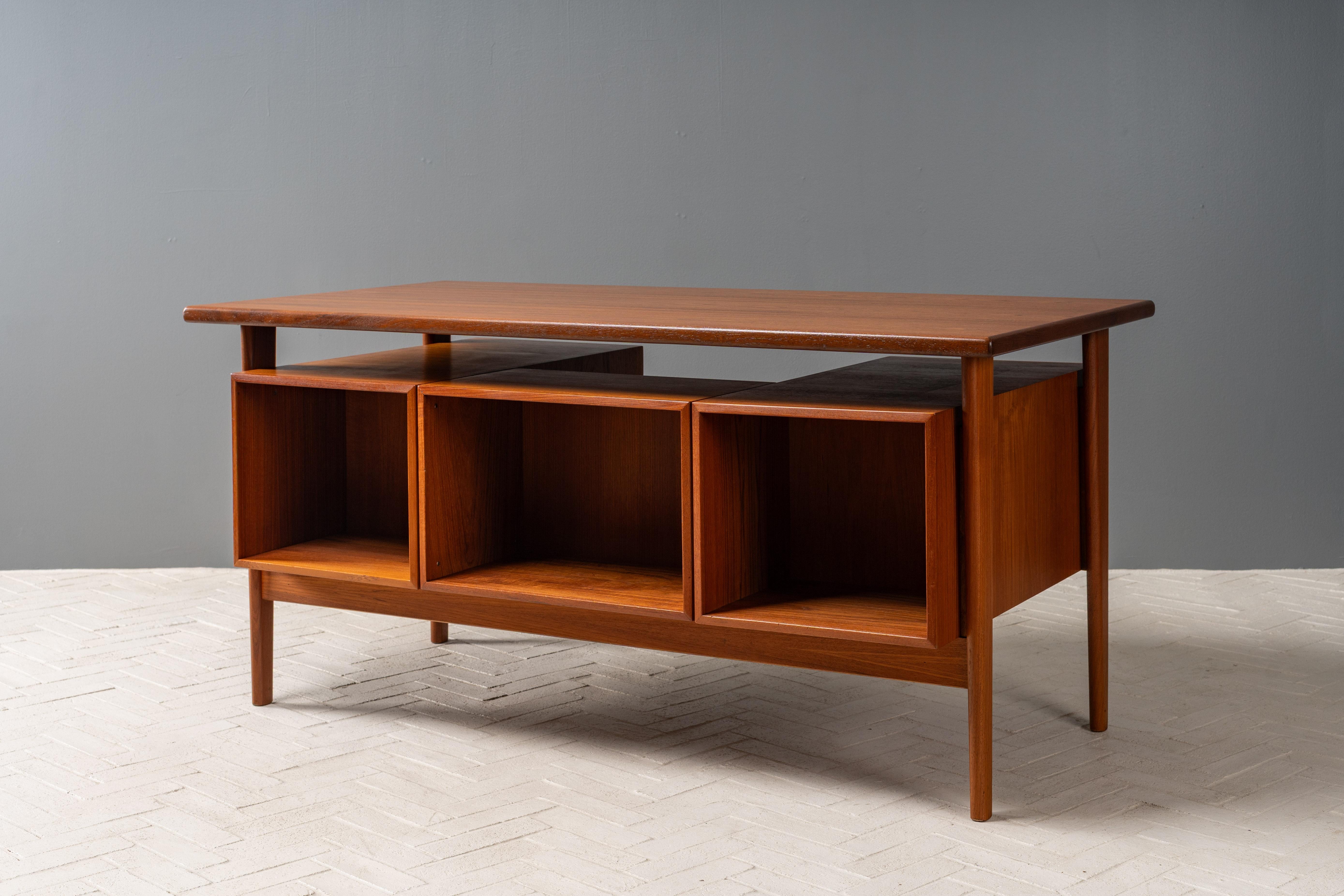 Denmark, ca. 1960s. An impressive Model FM 60 executive desk by Kai Kristiansen for Feldballes Møbelfabrik. Features thoughtful old growth teak construction with six nicely sized drawers - each finished with Kristiansen’s signature carved pulls.