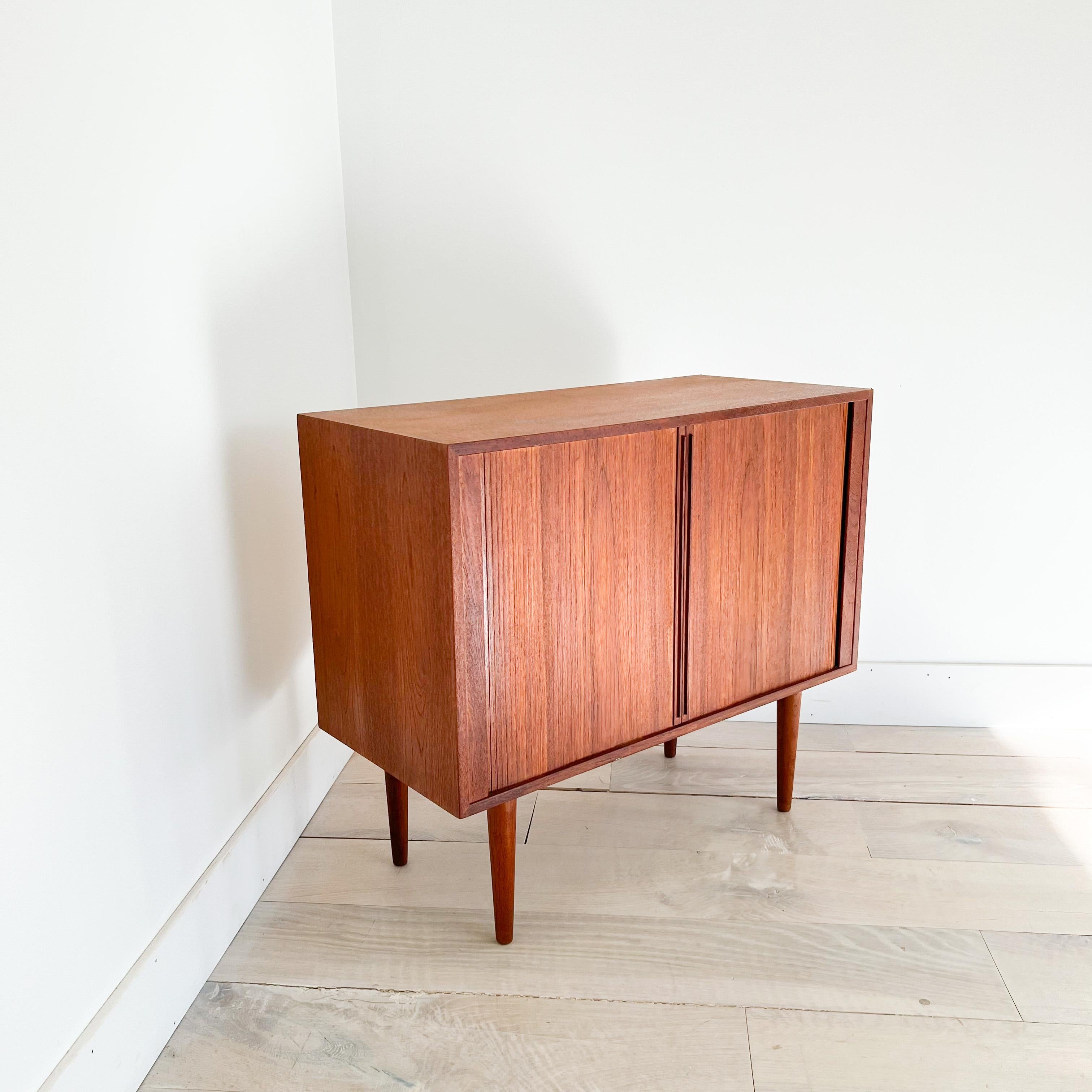 Mid-Century Modern Danish teak record cabinet with tambour doors designed by Kai Kristiansen. The top has been sanded and restored. Some light scuffing/scratching from age appropriate wear.