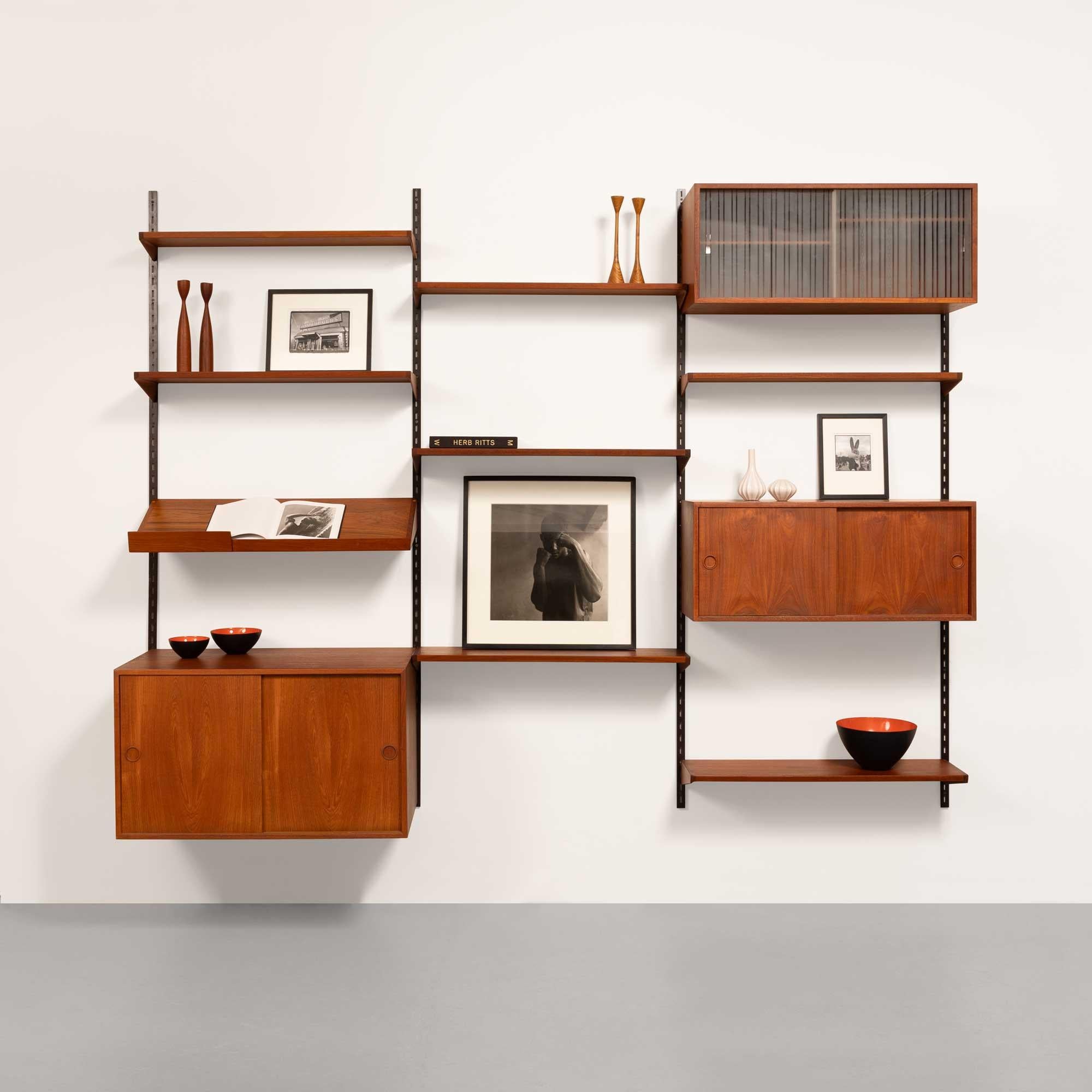 Kai Kristiansen’s wall system for FM Møbelafabrik is a modular shelving and storage system that exemplifies the versatility and elegance of Danish Modern design. Developed in the 1950s and 60s, this system reflects Kristiansen’s commitment to