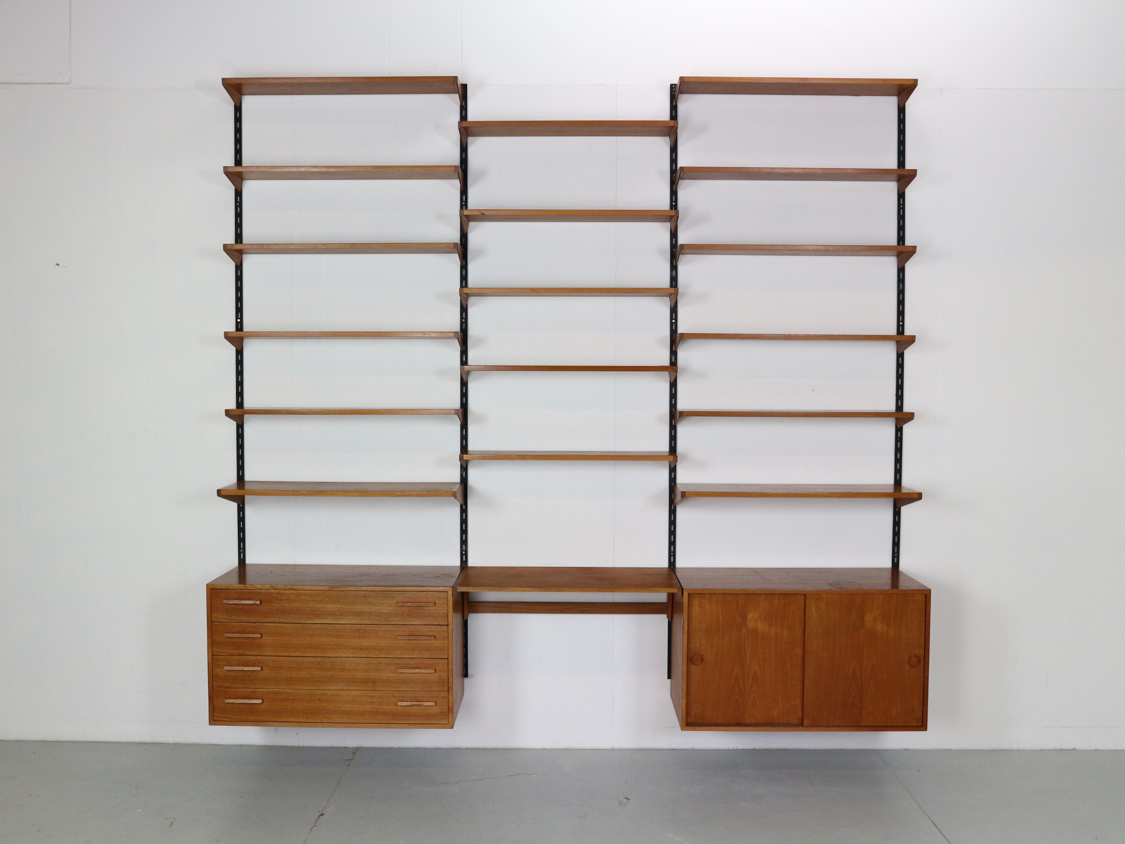 Mid Century modern period famous danish furniture designer Kai Kristiansen design this gorgeous and very practical wall unit shelving system.
It was manufactured by Feldballes Møbelfabrik in 1960's period, Denmark.

The shelves and the cabinets