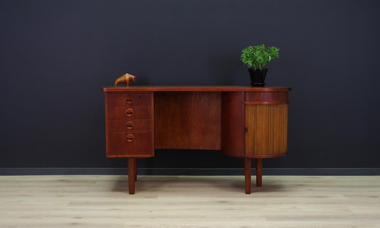 Brilliant writing desk from the 1960s-1970s, Danish design. Form designed by one of the leading Danish designers - Kai Kristiansen. Finished with teak wood veneer. Fantastic front with four drawers, opened bar with mirror, and a sliding round