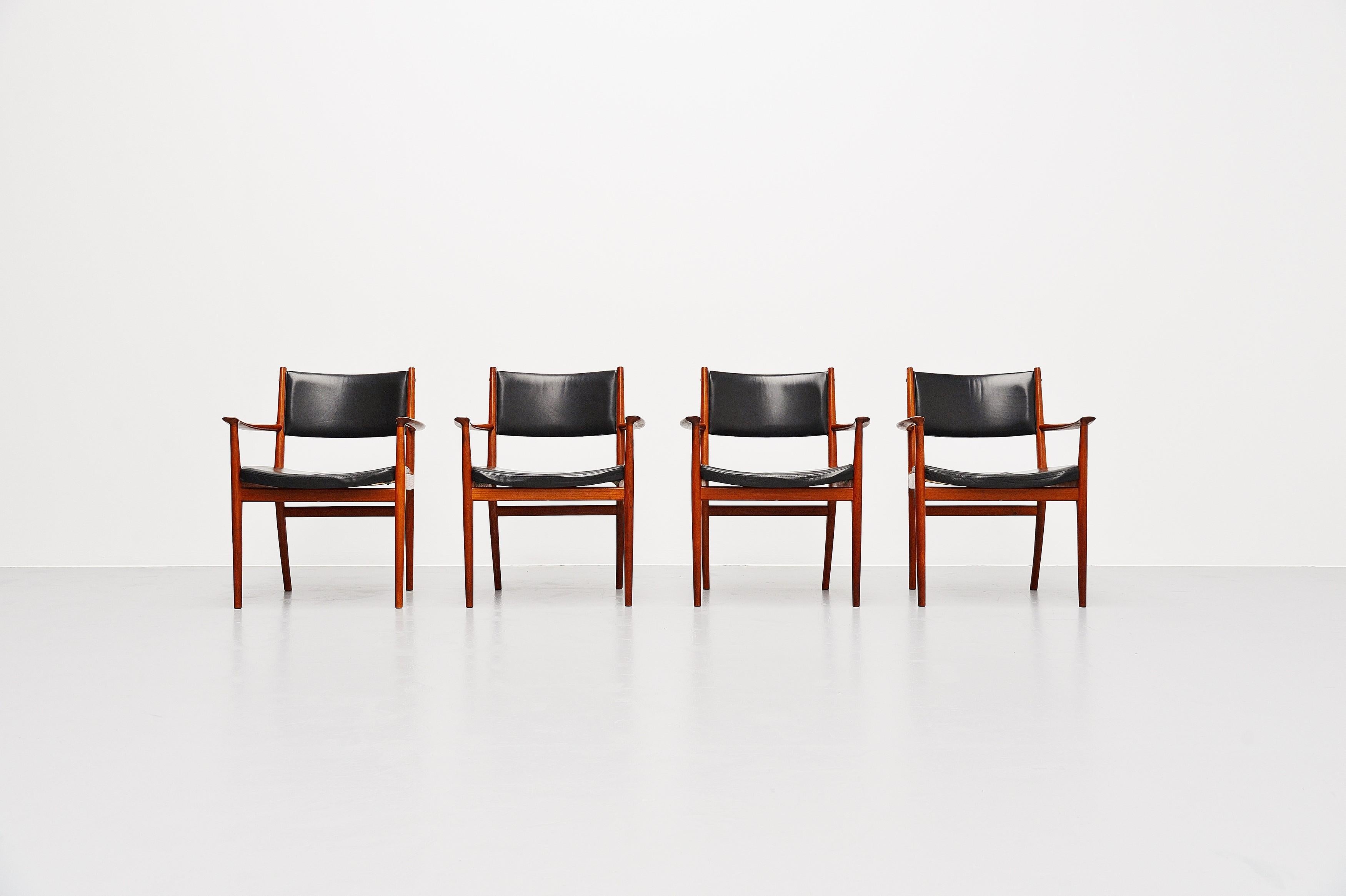 Nice shaped set of 4 armchairs designed by Kai Lyngeldt Larsen and manufactured by Soren Willadsen, Denmark, 1960. The chairs have a solid teak frame and original black leather upholstery with nice patina from age and usage but no damages. The