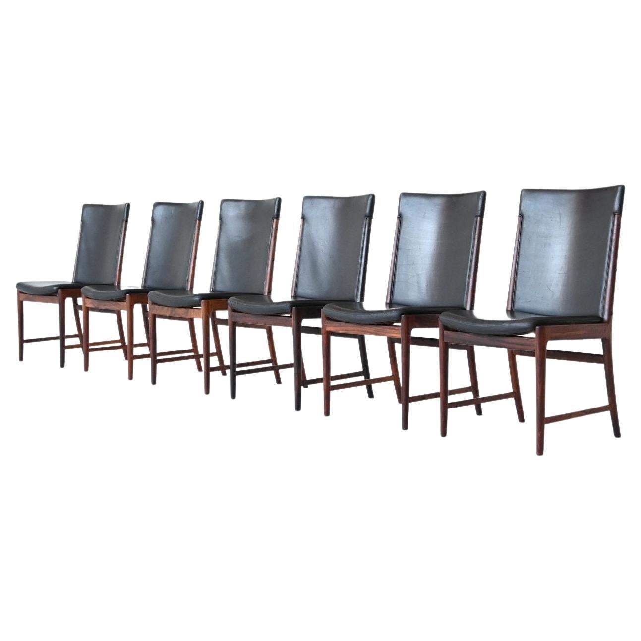 Stunning set of six beautiful shaped and well-crafted dining chairs designed by Kai Lyngfledt Larsen and manufactured by Søren Willadsen, Denmark 1960. These chairs are made of nicely grained solid Brazilian rosewood and the seats are upholstered