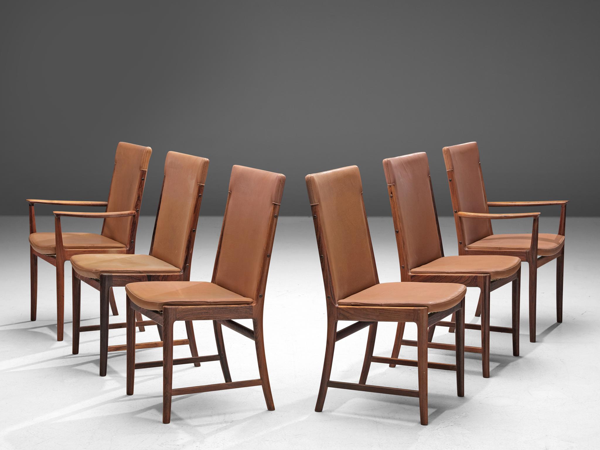 Kai Lyngfeldt Larsen for Søren Willadsen, set of six dining chairs, rosewood and leather, Denmark, 1950s.

Elegant dining chairs with a high back designed by Kai Lyngfeldt Larsen. The set consists of four chairs without arms and two with armrests.