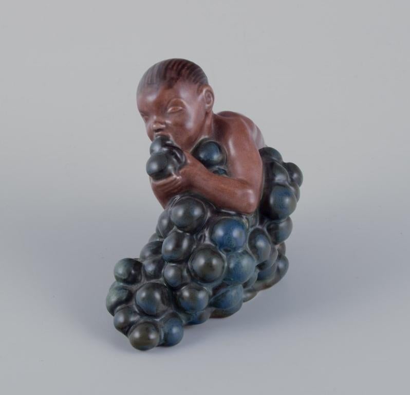 Glazed Kai Nielsen for Bing & Grøndahl. Stoneware figurine. Little Bacchus with Grapes. For Sale