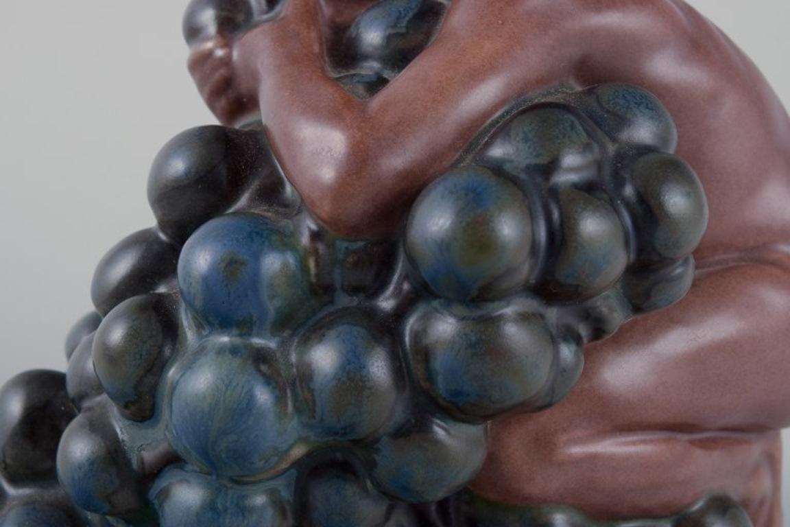 Kai Nielsen for Bing & Grøndahl. Stoneware figurine. Little Bacchus with Grapes. 2