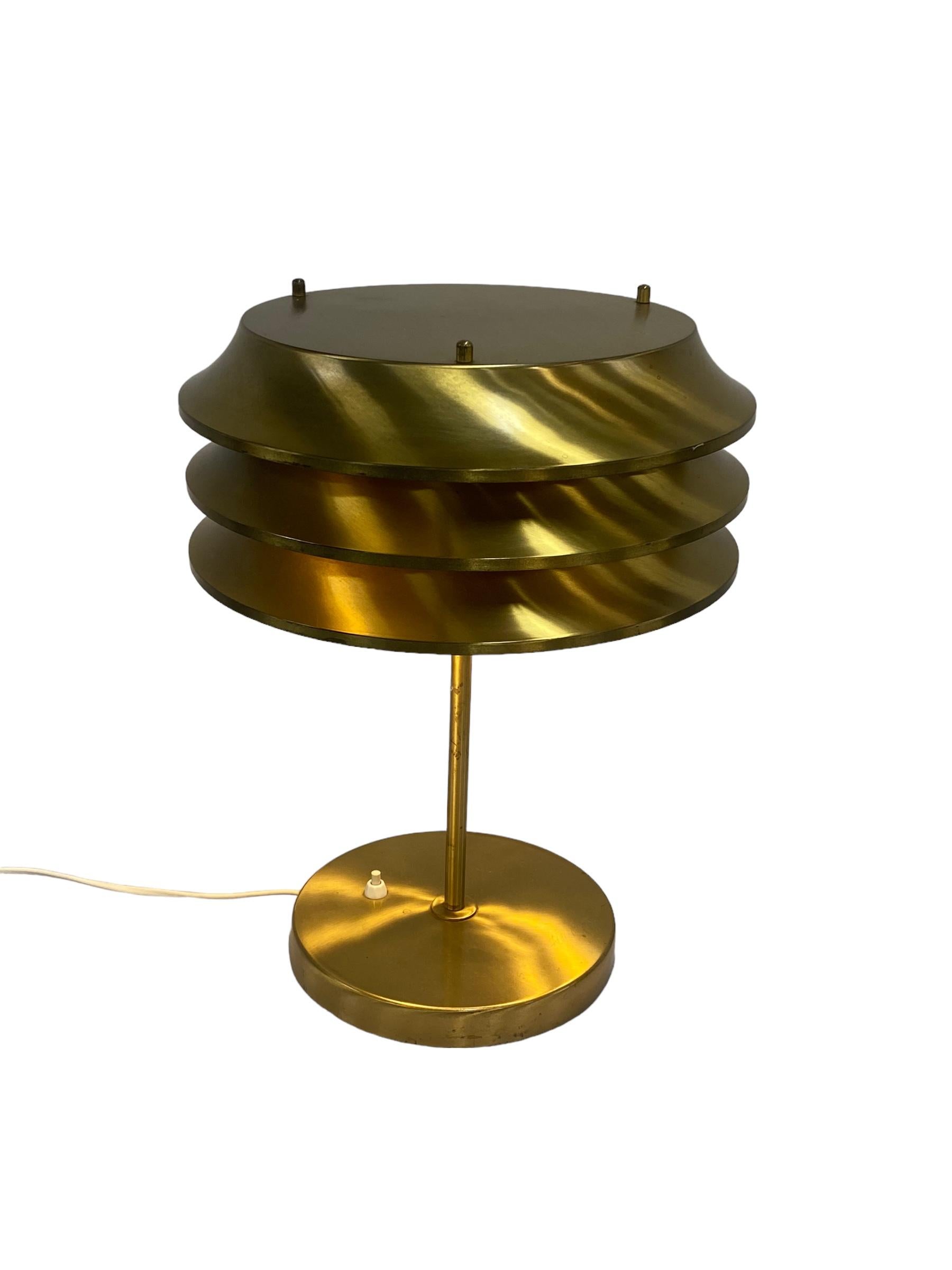 This lamp was designed by Kai Ruokonen, originally for the Vaakuna Hotel in Helsinki in the 1970s. The same model was also used later in the Palace Hotel Helsinki. A very simple yet elegant heavy duty lamp in full brass with a beautiful patina.