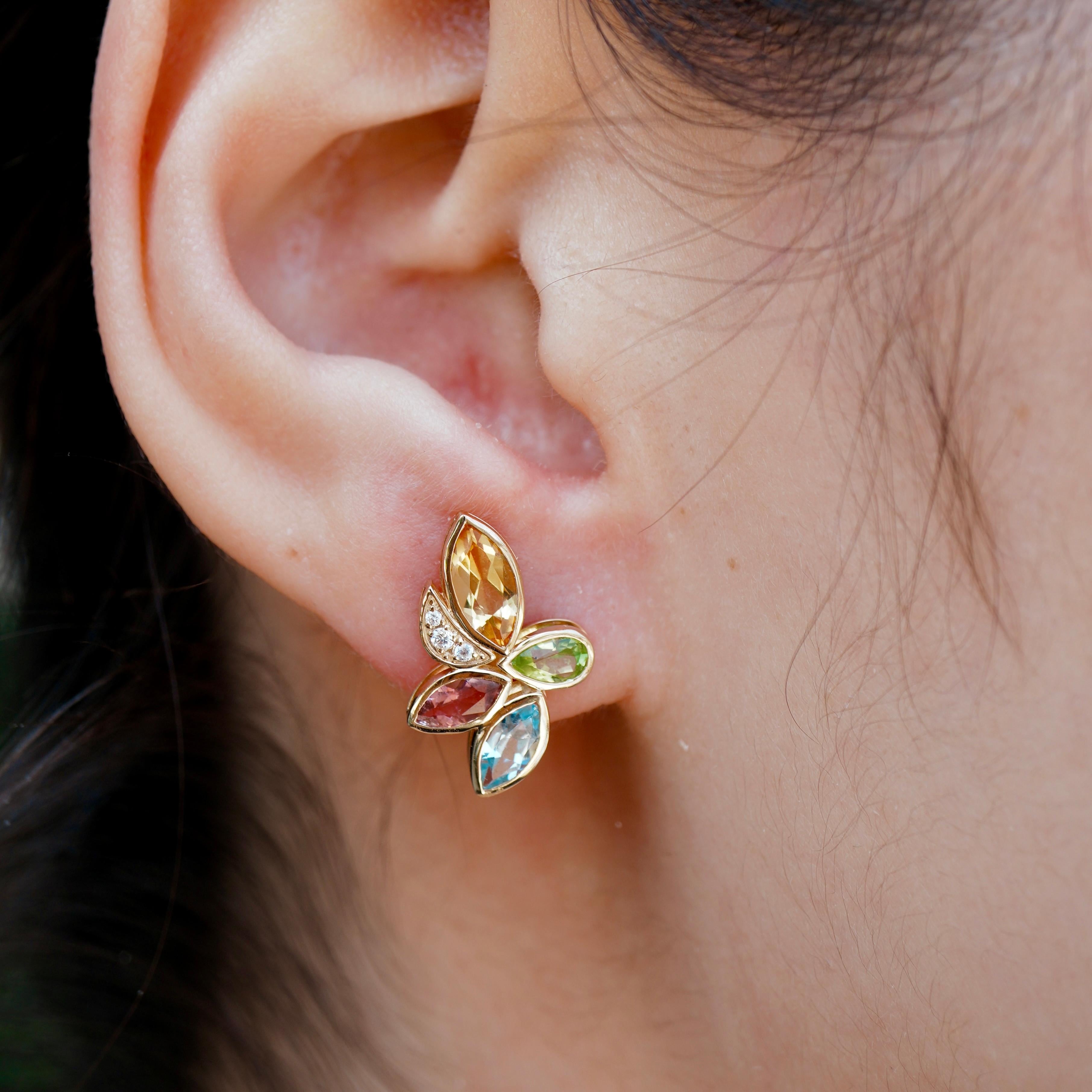 Crafted in 14K yellow gold, each earring features a radiant mix of natural peridot, citrine, aquamarine, amethyst, and tourmaline—arranged like petals in a sun-drenched garden and accented with sparkling diamonds. 
Inspired by the lush vibrance of