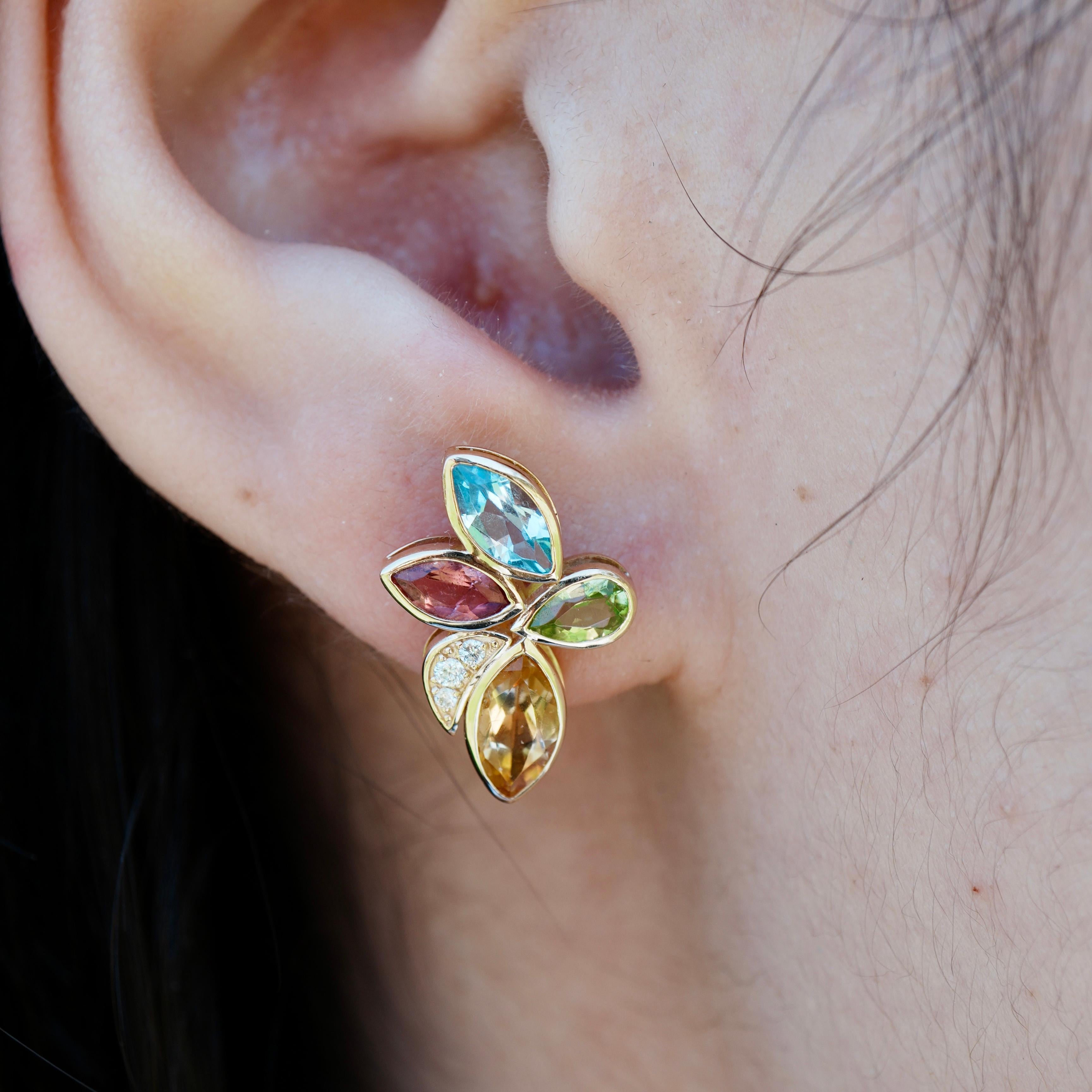 Crafted in 14K yellow gold, each earring features a radiant mix of natural peridot, citrine, aquamarine, amethyst, and tourmaline—arranged like petals in a sun-drenched garden and accented with sparkling diamonds. 
Inspired by the lush vibrance of