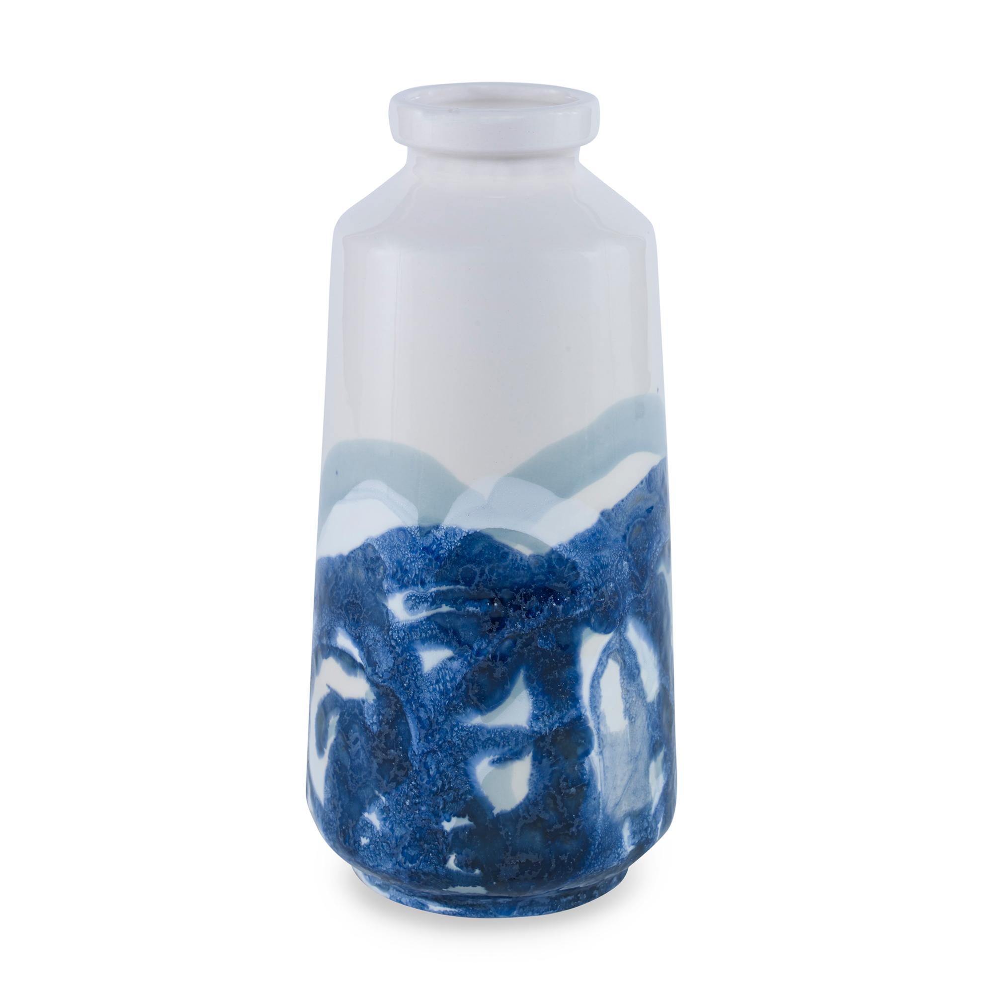 A hand painted, earthenware bottle pot with a reactive blue glaze. Due to the handmade nature of this product, variation is to be expected from piece to piece.
 