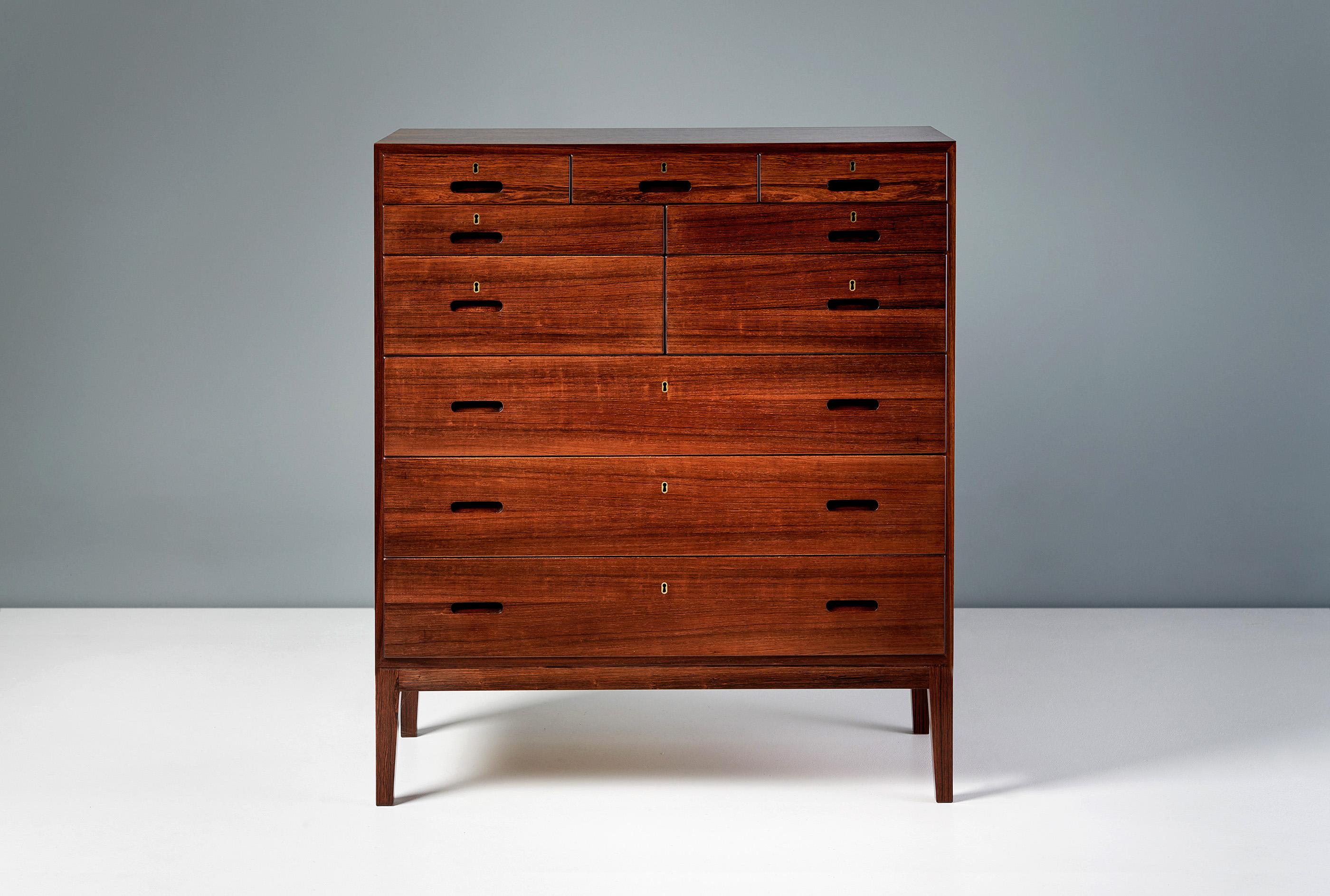 Kai Winding - Chest of Drawers, c1950s

Tall chest of drawers from Danish designer Kai Winding produced in the 1950s. The chest features mahogany lined drawers of varying sizes with solid rosewood drawer fronts and base. Each drawer is lockable.
