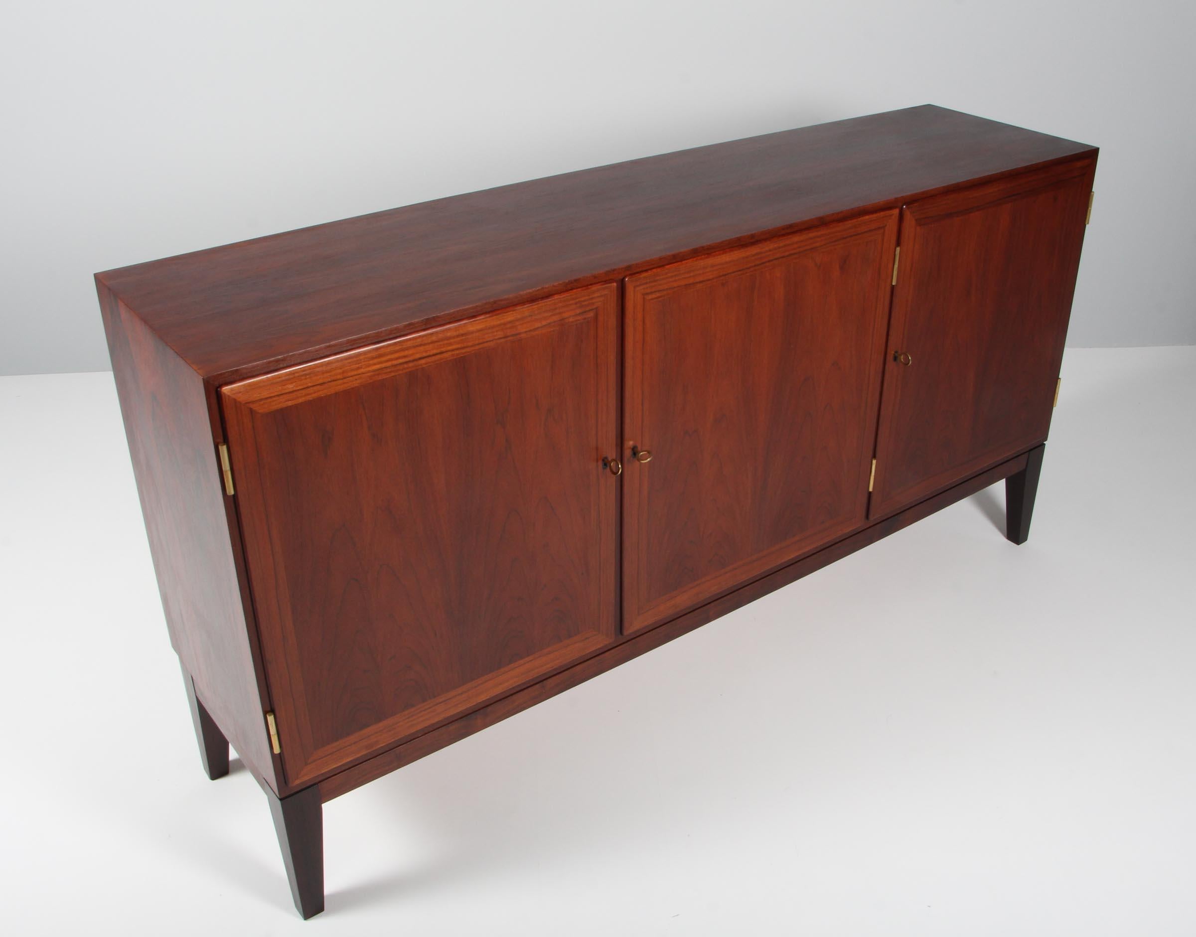 Kai Winding cabinet in partly solid rosewood. With doors.

 