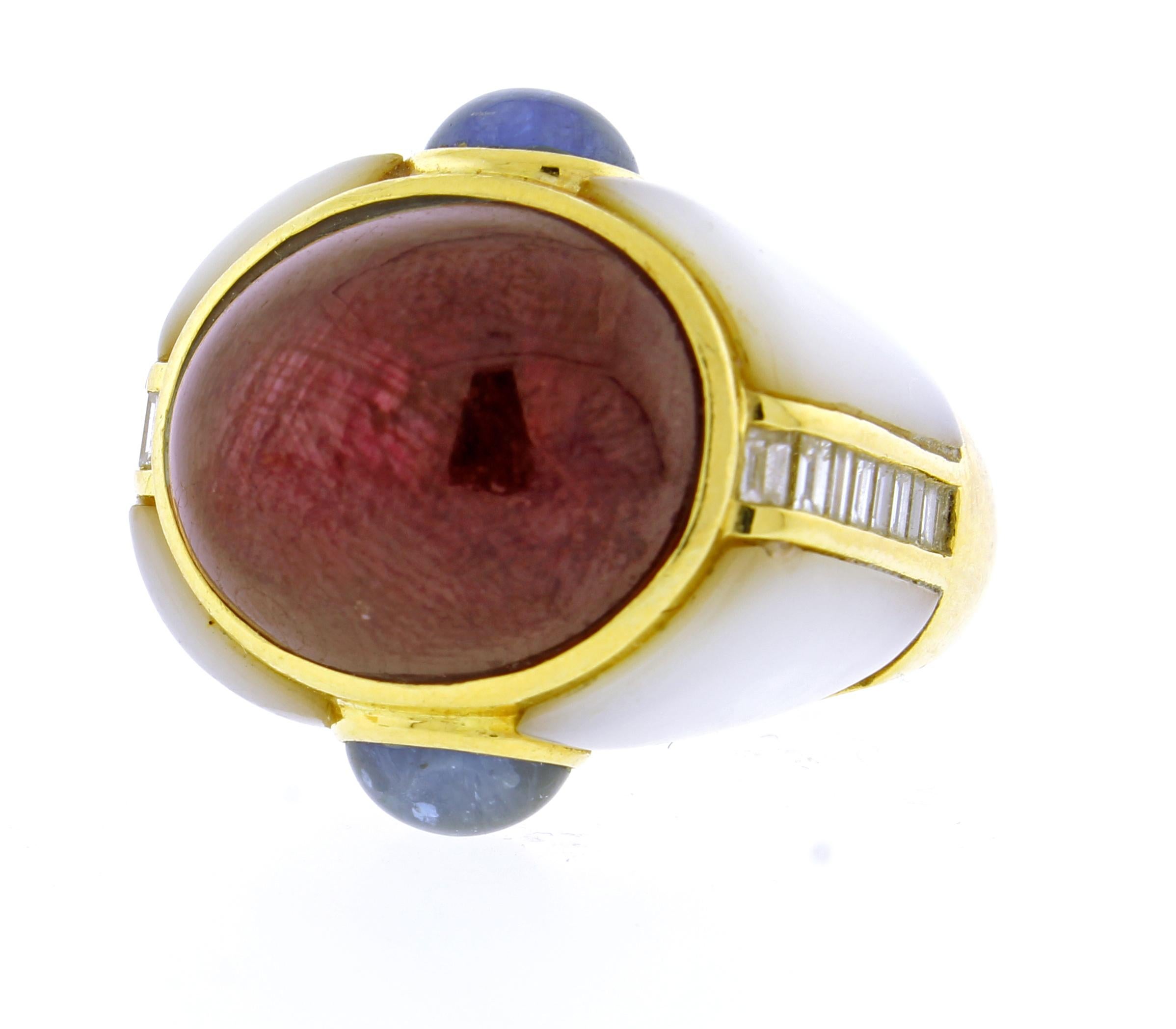 From  Kai-Yin Lo, a Cabochon Ruby, set with sapphire and diamond in a mother of pearl dome ring.
♦ Designer: Kai-Yin Lo 
♦ Metal: 18 karat
♦ Cabochon Ruby 16.½ X 13.½mm
♦ Cabochons sapphires  6 ½ X  5 ½
♦ Circa 2010
♦ 20 Diamonds=.90 carats
♦ Size